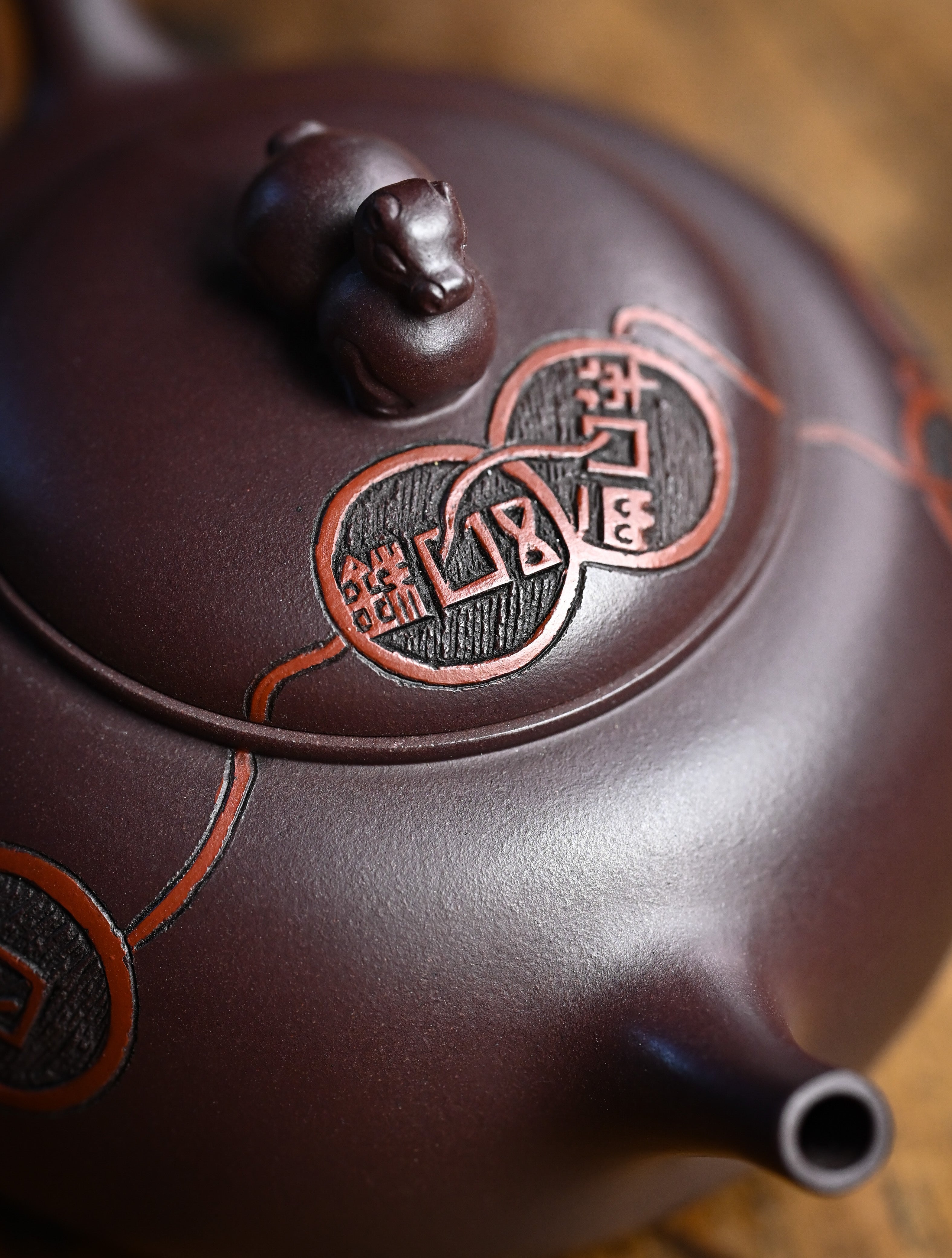 YANYOO handmade Yixing teapot featuring Zini clay and ancient Chinese coin sculpture, lifestyle detail top side.