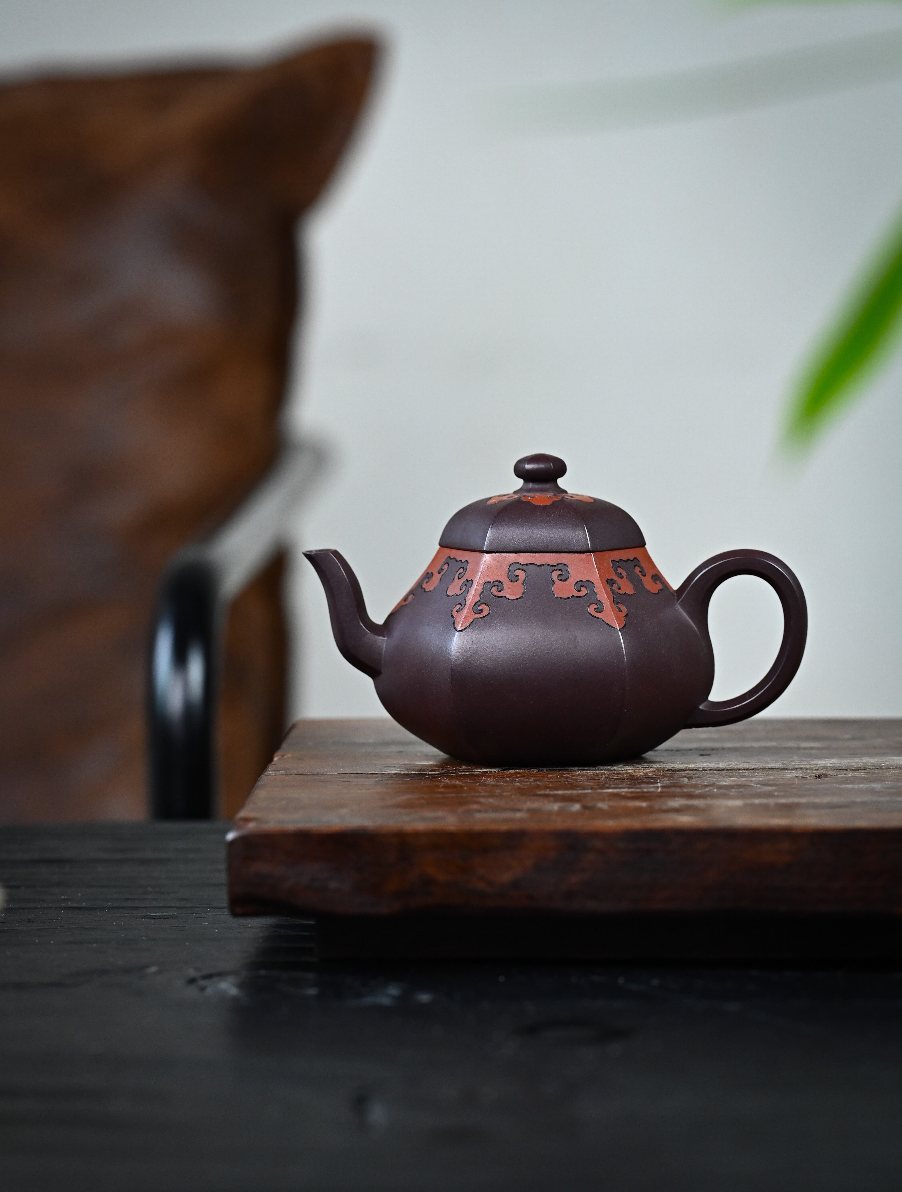 YANYOO handmade Yixing teapot featuring a pear shape, Grade A Zini clay and the "color decoration method" craftsmanship, lifestyle wide-angle left side.
