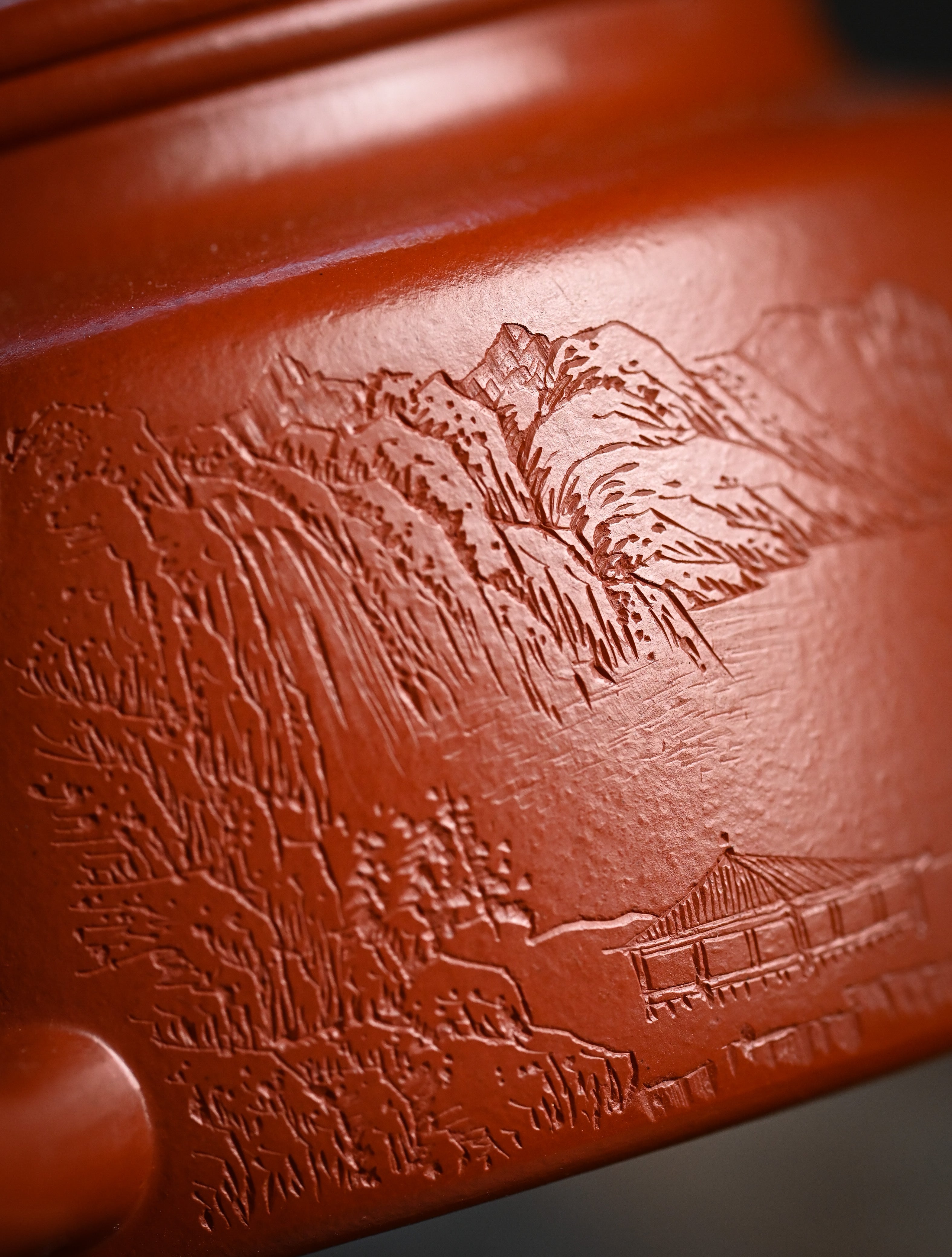 YANYOO handmade Yixing teapot featuring Zhuni clay and Chinese landscape engraving, lifestyle detail front side.