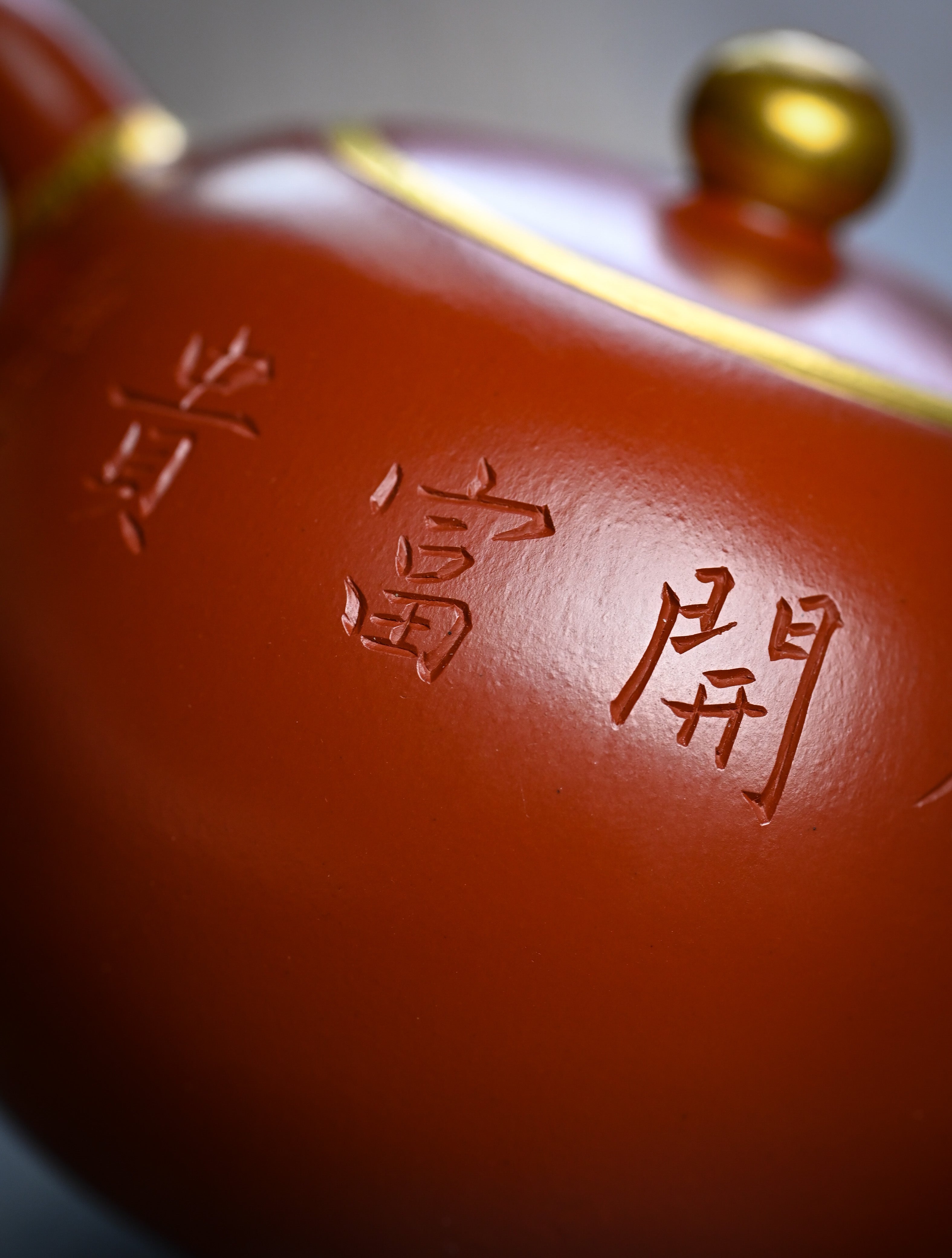 YANYOO handmade Yixing teapot featuring premium Zhuni clay and relief engravings, lifestyle detail rear.