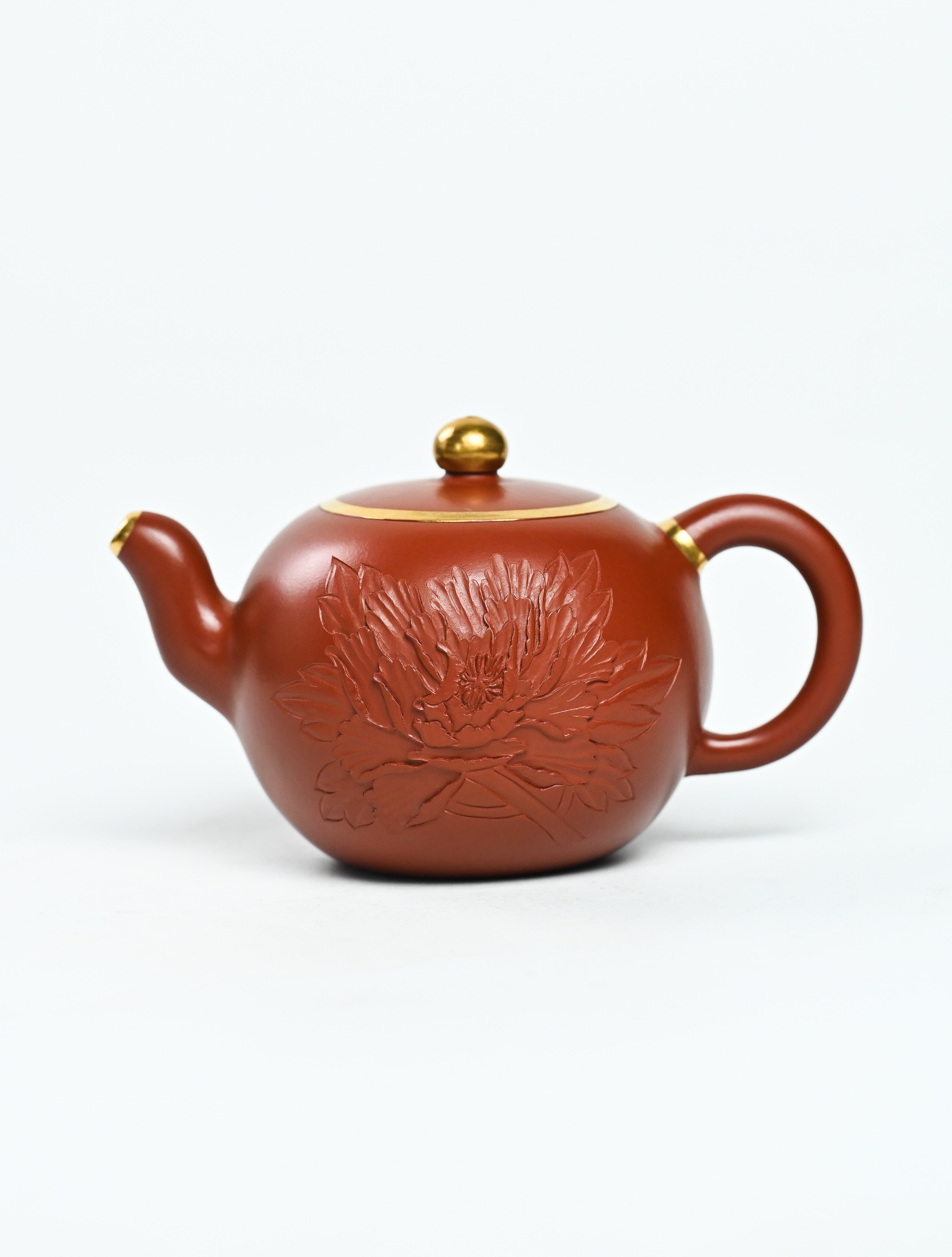 YANYOO handmade Yixing teapot featuring premium Zhuni clay and relief engravings, product left side.