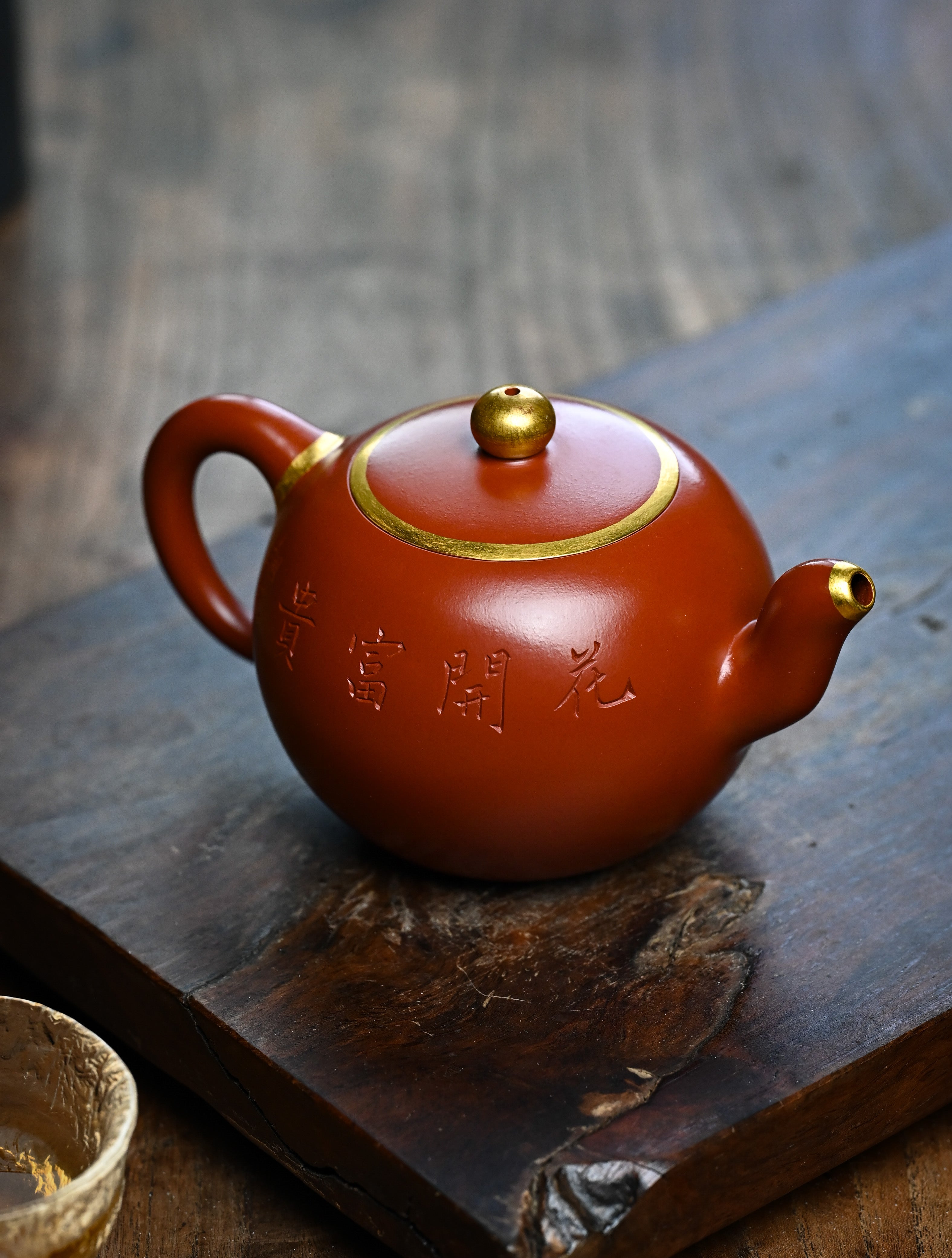 YANYOO handmade Yixing teapot featuring premium Zhuni clay and relief engravings, lifestyle left side.