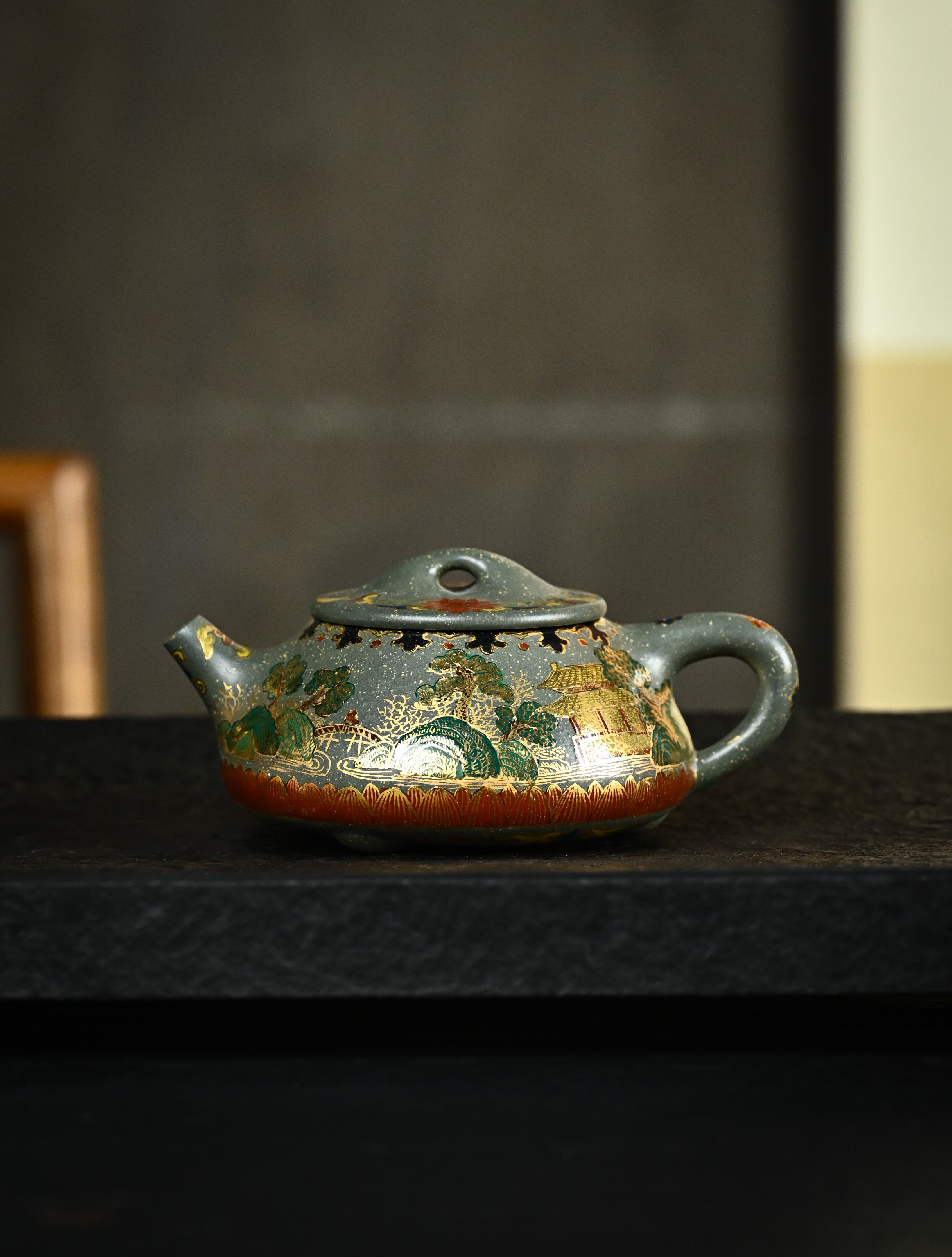 YANYOO handmade Yixing teapot featuring Lvni clay and delicate Falangcai enamel, Jingzhou Shi Piao, lifestyle wide-angle left side.