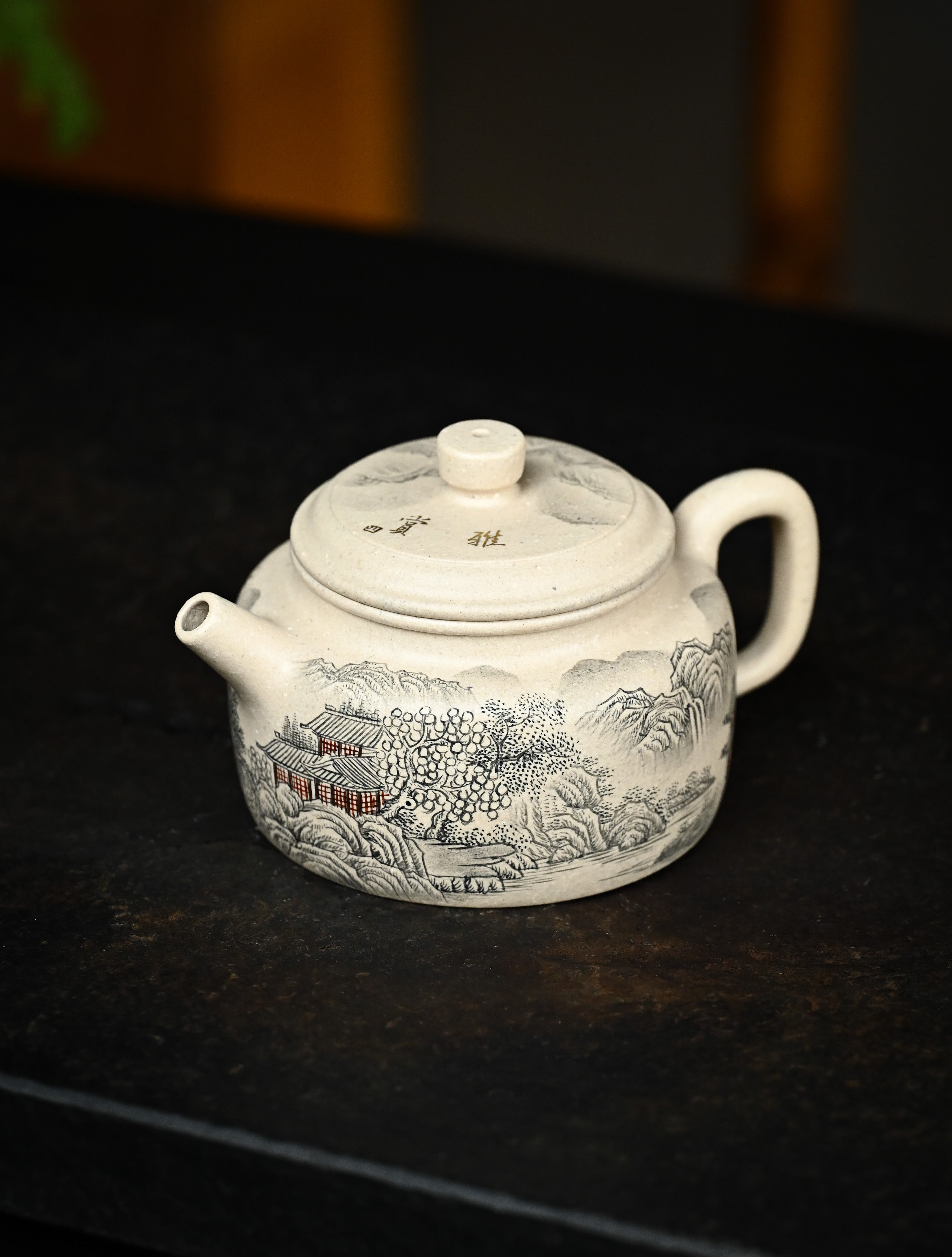 YANYOO handmade Yixing teapot featuring suet white jade Duanni clay and delicate ink painting technique from Jingdezhen China, lifestyle left side.