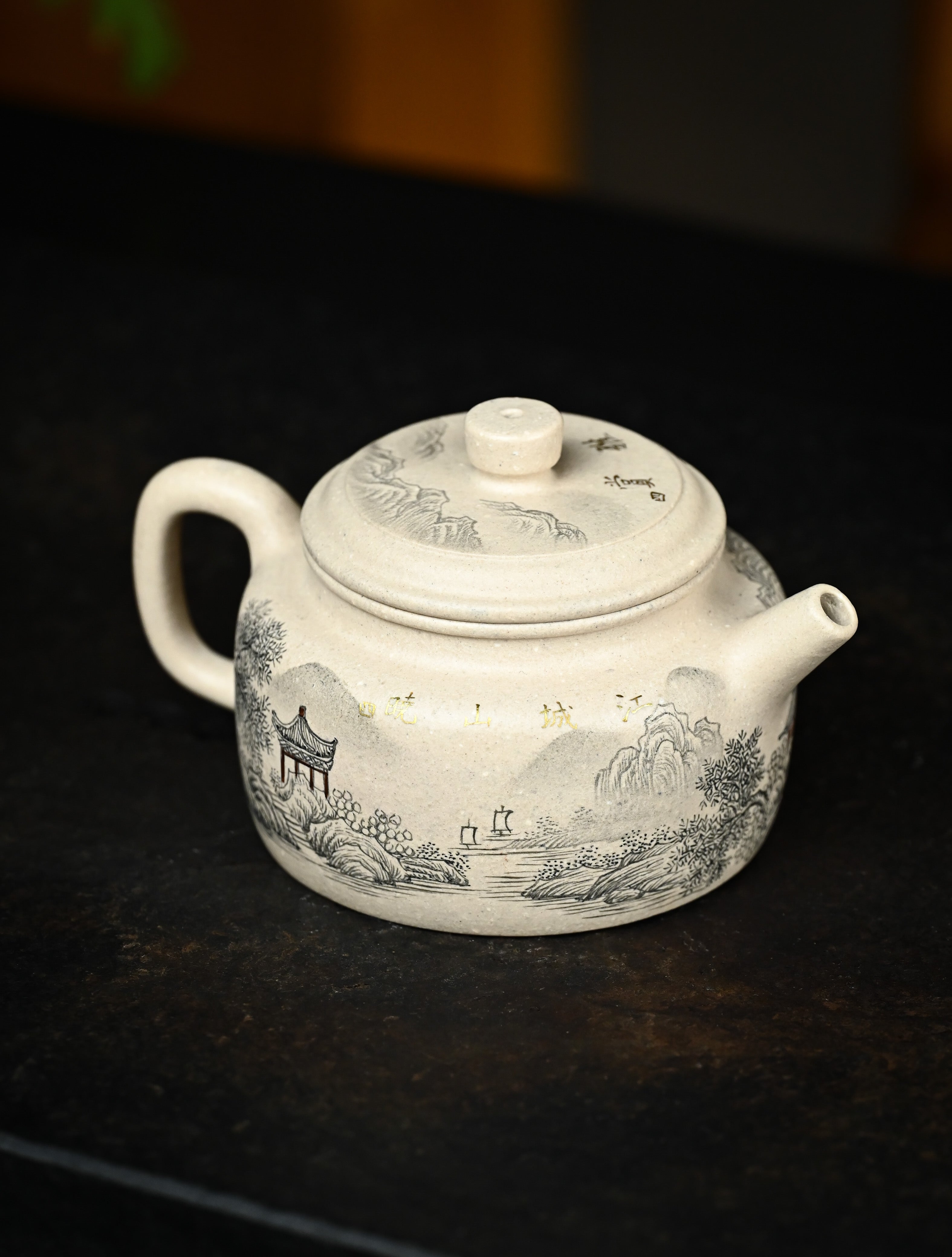 YANYOO handmade Yixing teapot featuring suet white jade Duanni clay and delicate ink painting technique from Jingdezhen China, lifestyle right side.