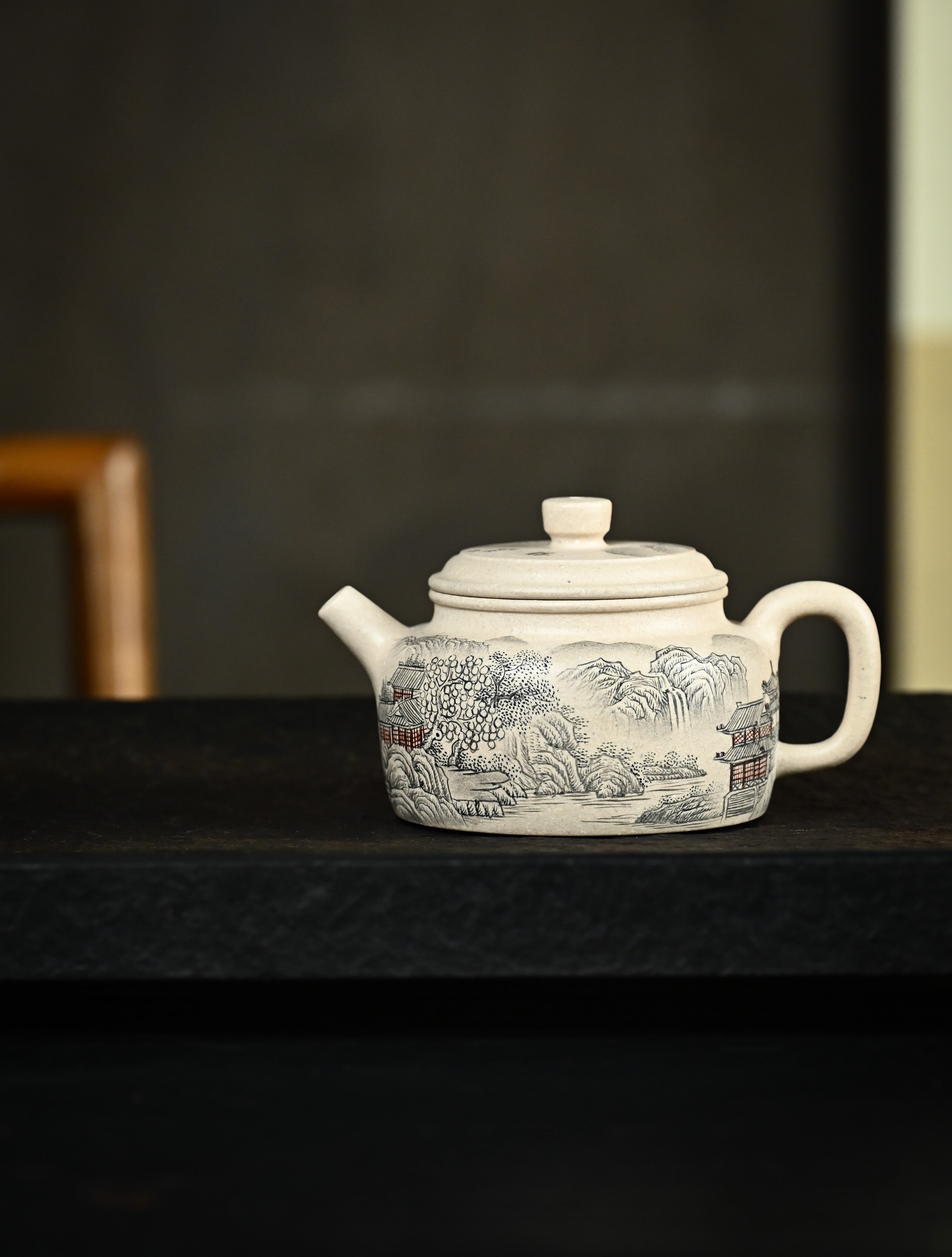 YANYOO handmade Yixing teapot featuring suet white jade Duanni clay and delicate ink painting technique from Jingdezhen China, lifestyle wide-angle left side.