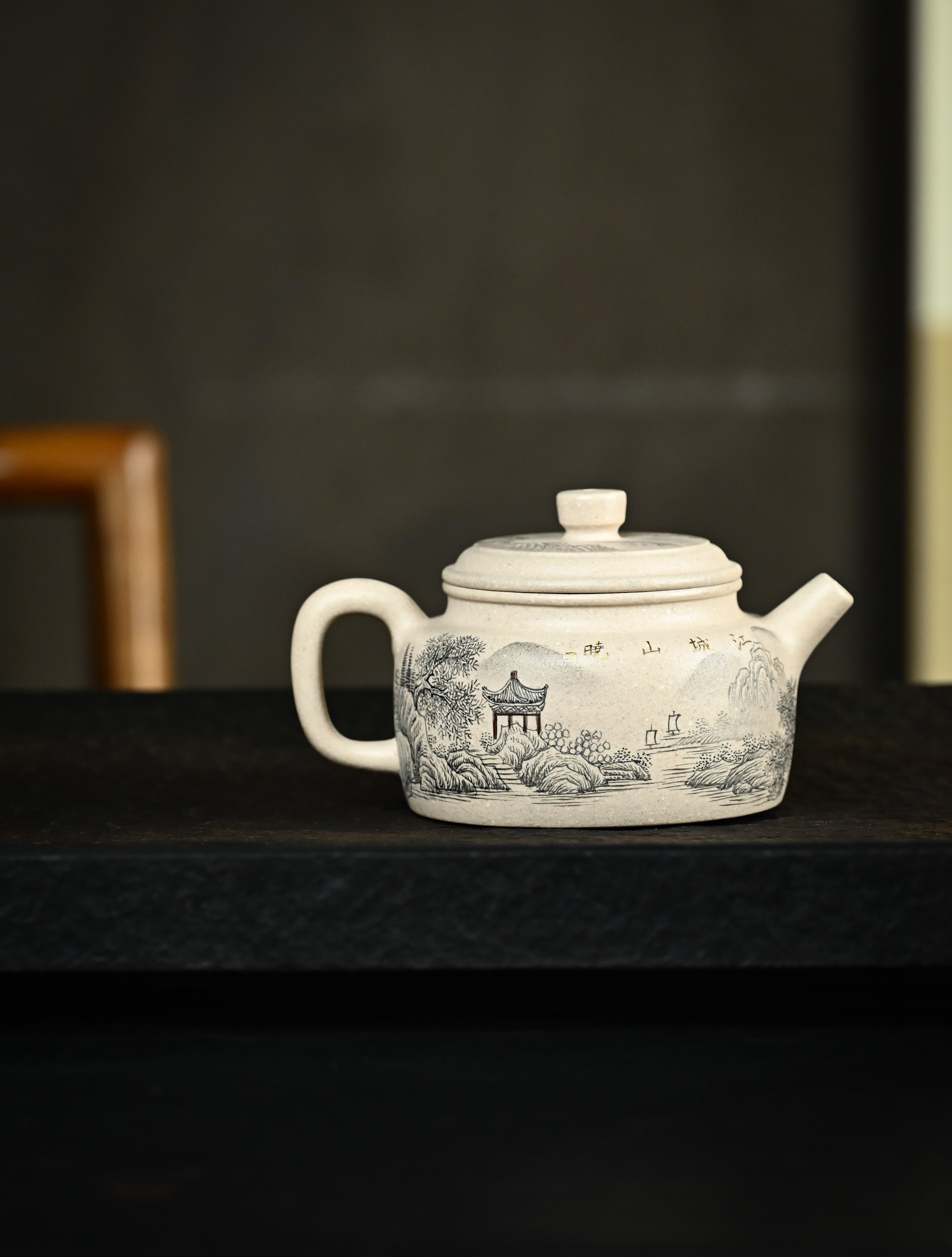YANYOO handmade Yixing teapot featuring suet white jade Duanni clay and delicate ink painting technique from Jingdezhen China, lifestyle wide-angle right side.