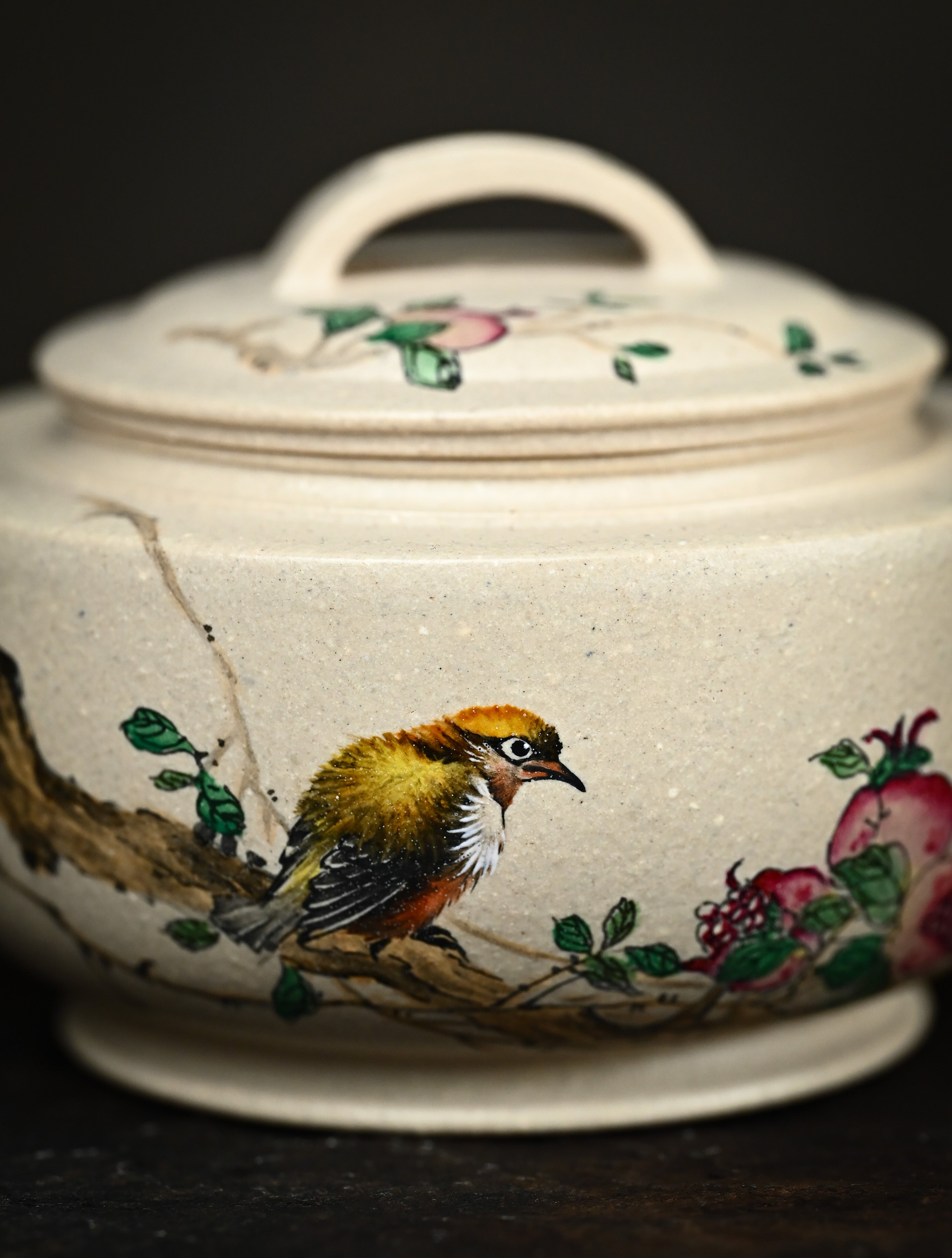YANYOO handmade Yixing teapot featuring suet white jade Duanni clay and delicate bird-and-pomegranate themed clay painting, Gong Deng, lifestyle detail front side.