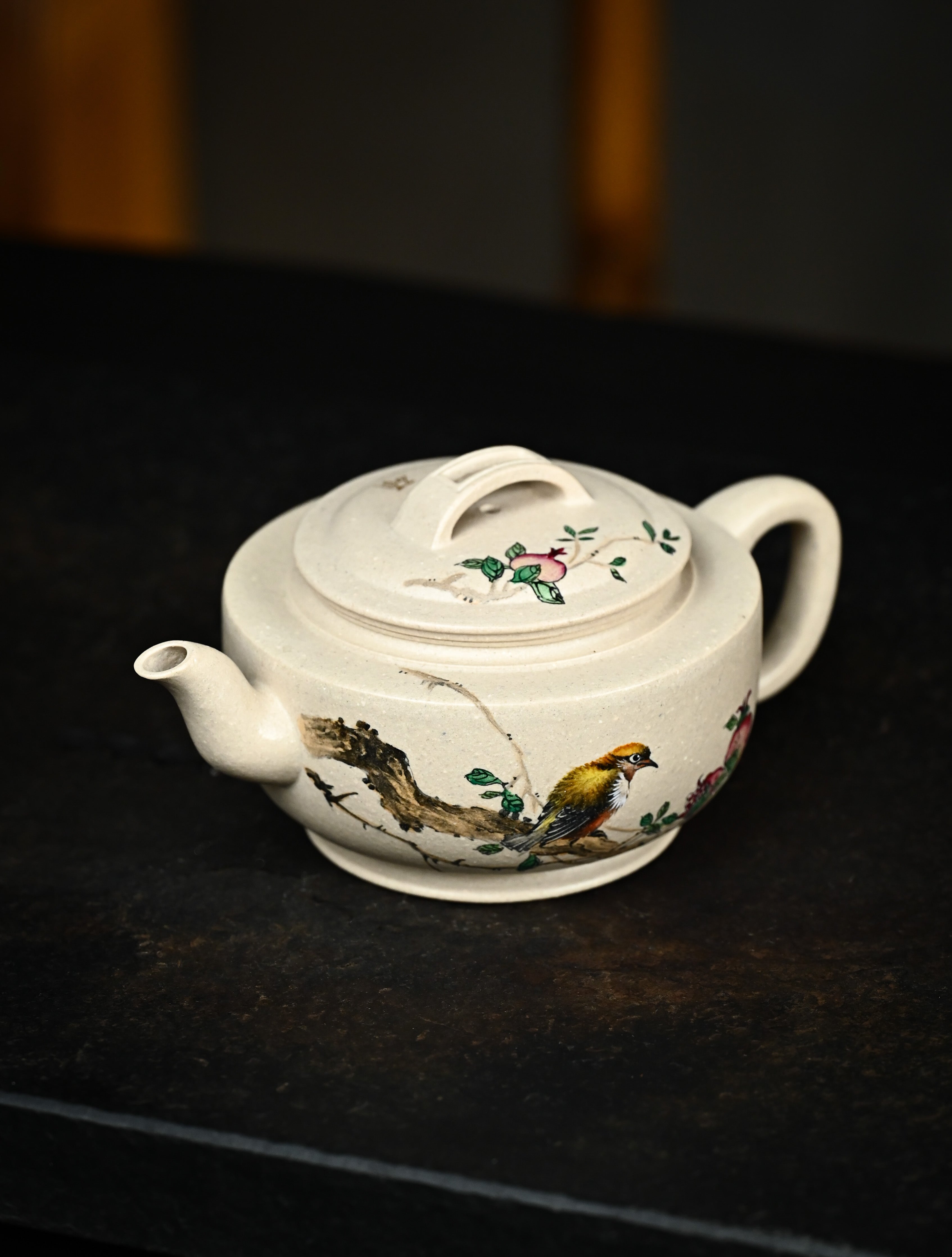 YANYOO handmade Yixing teapot featuring suet white jade Duanni clay and delicate bird-and-pomegranate themed clay painting, Gong Deng, lifestyle left side.