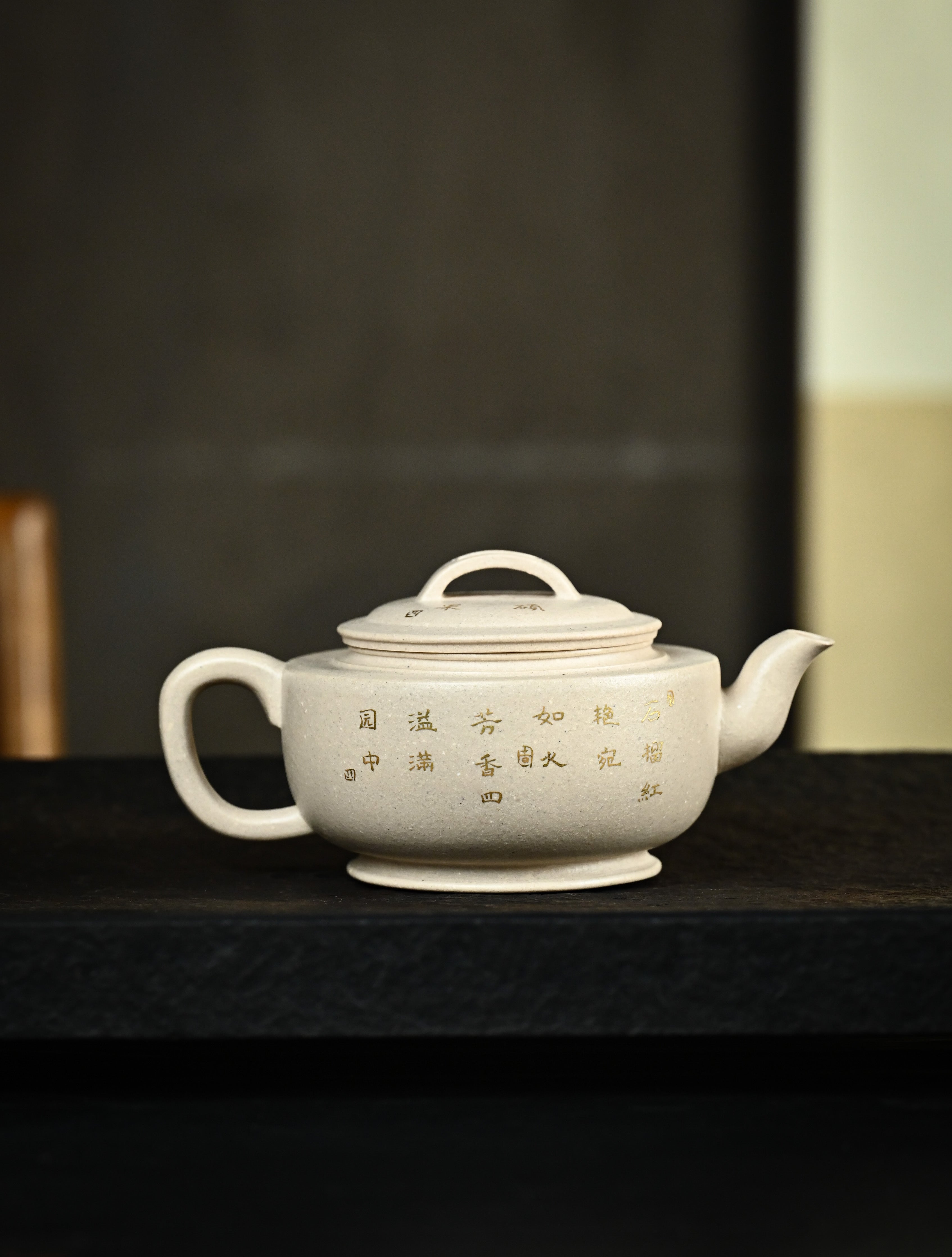 YANYOO handmade Yixing teapot featuring suet white jade Duanni clay and delicate bird-and-pomegranate themed clay painting, Gong Deng, lifestyle right side.