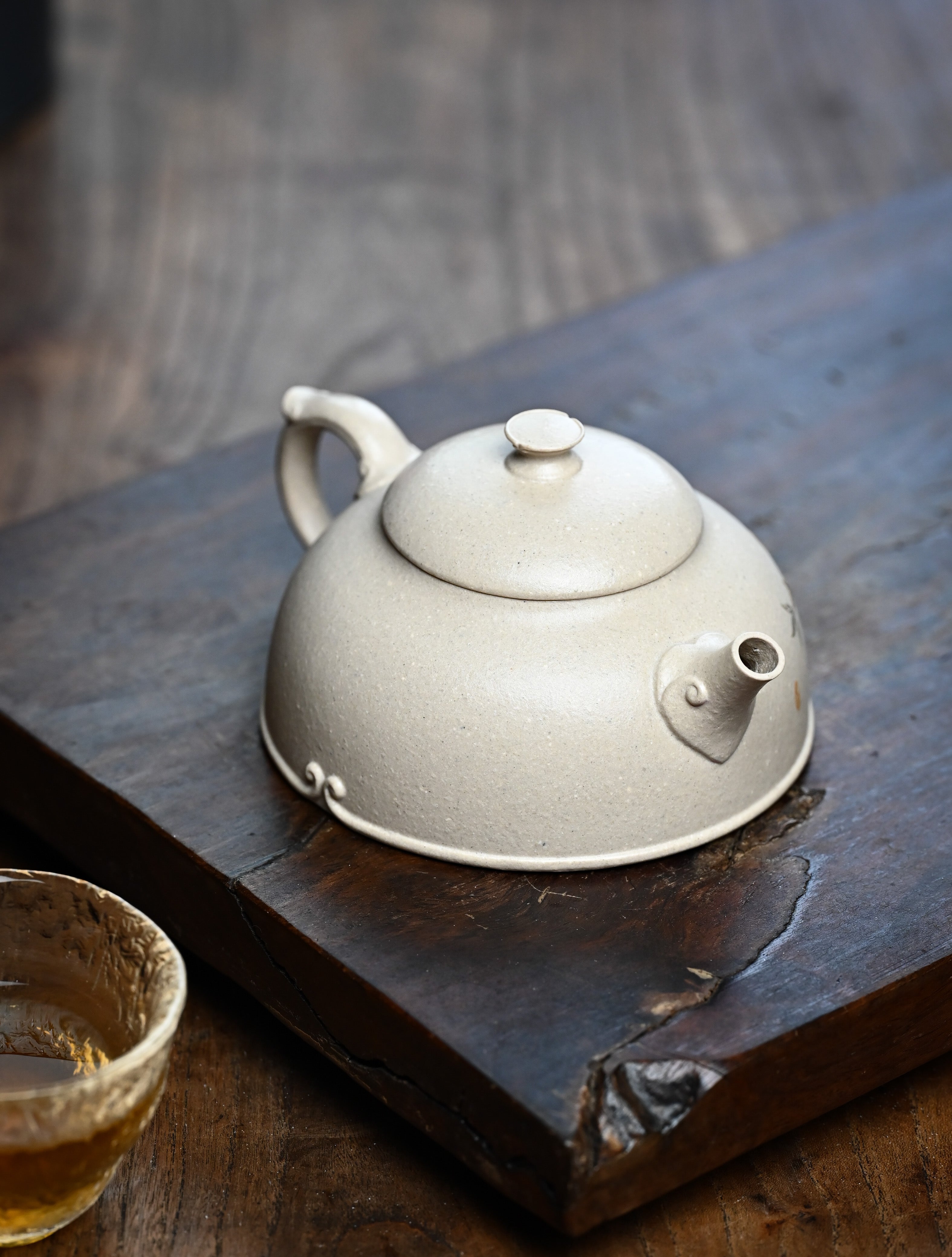 YANYOO handmade Yixing teapot featuring suet white jade Duanni clay and delicate bird-and-peach themed clay painting, lifestyle right side.
