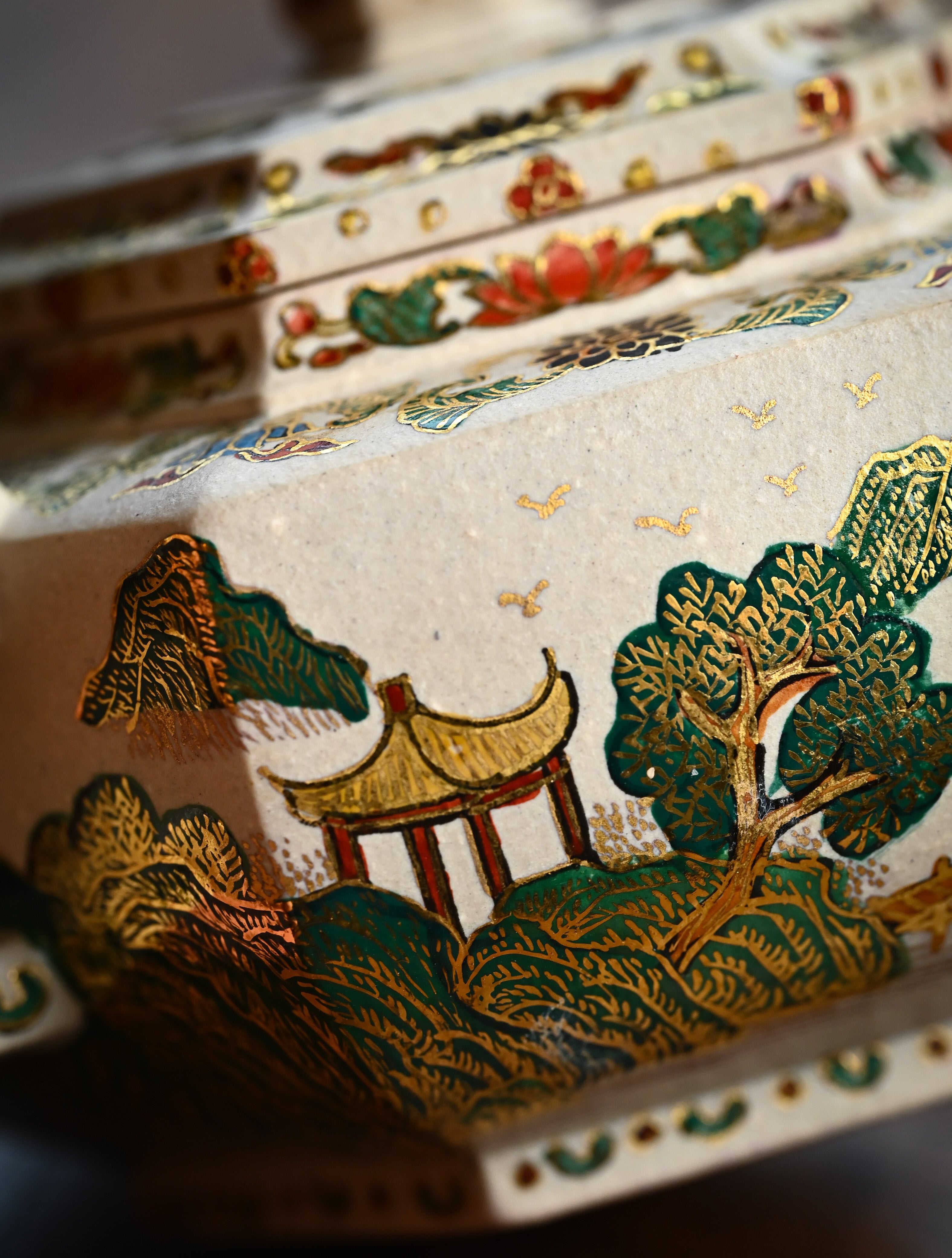 YANYOO handmade Yixing teapot featuring suet white jade Duanni clay and delicate Falangcai, lifestyle detail front side.