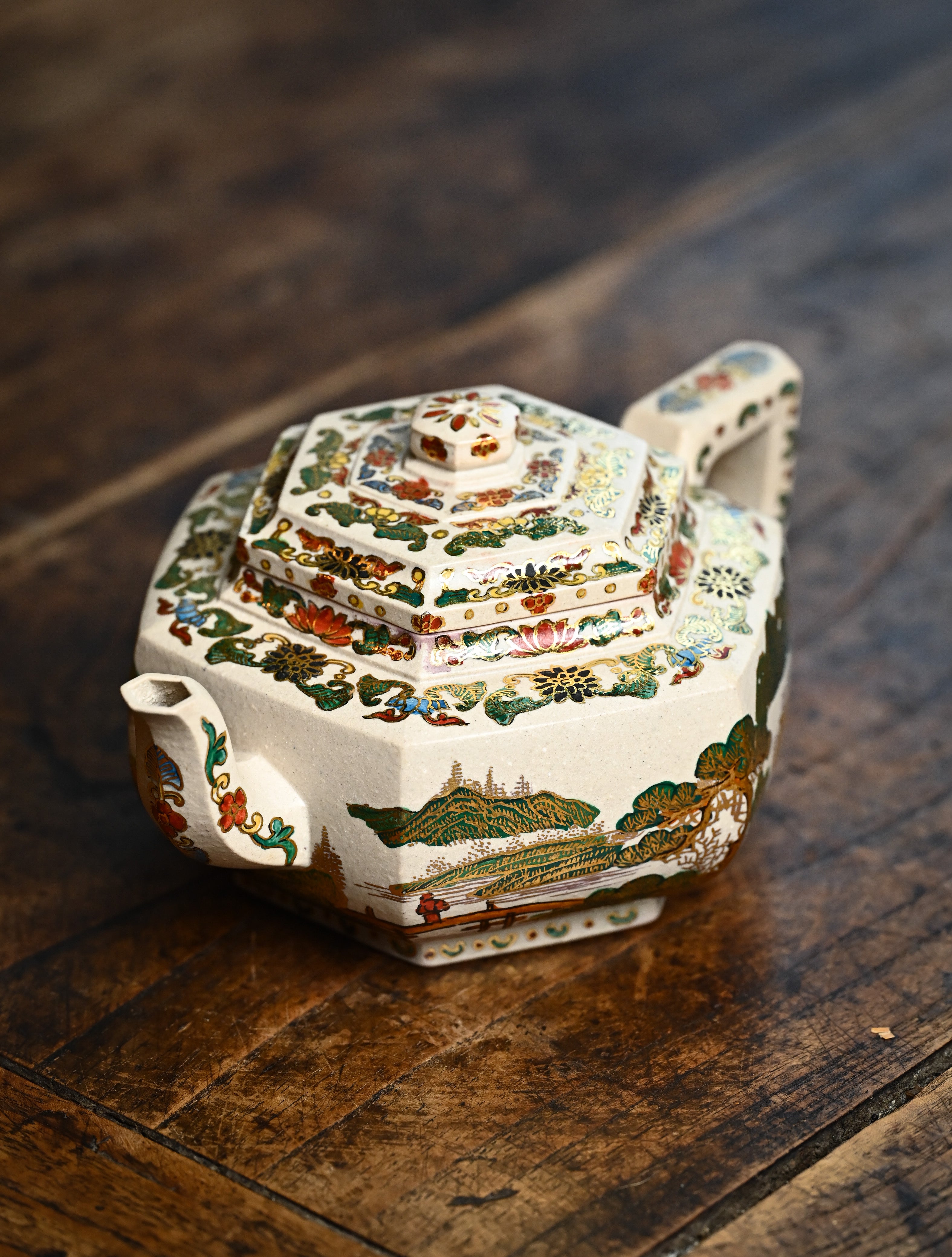 YANYOO handmade Yixing teapot featuring suet white jade Duanni clay and delicate Falangcai, lifestyle left side.