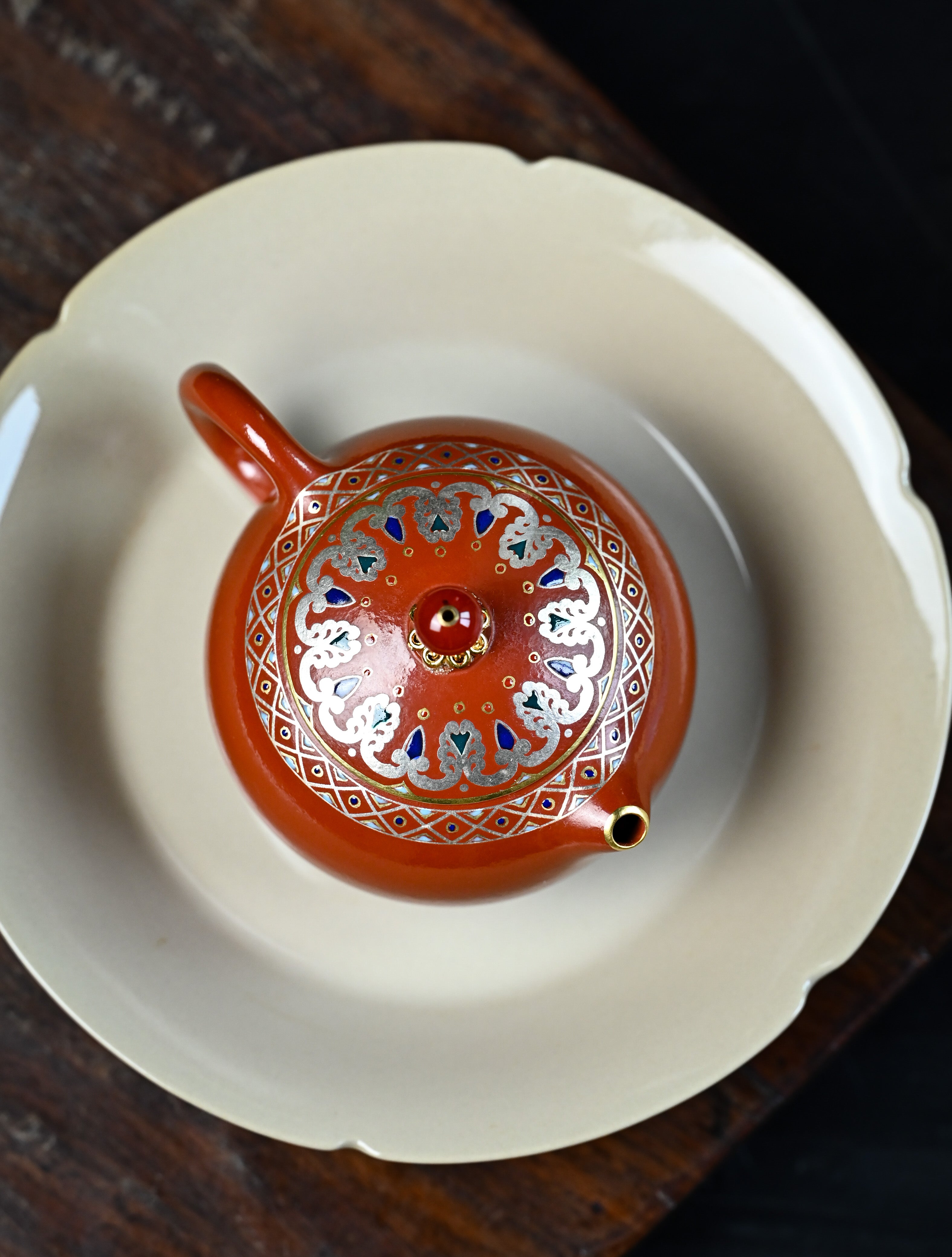 YANYOO handmade Yixing teapot featuring Shuimo polish technique and delicate Falangcai, lifestyle top side.