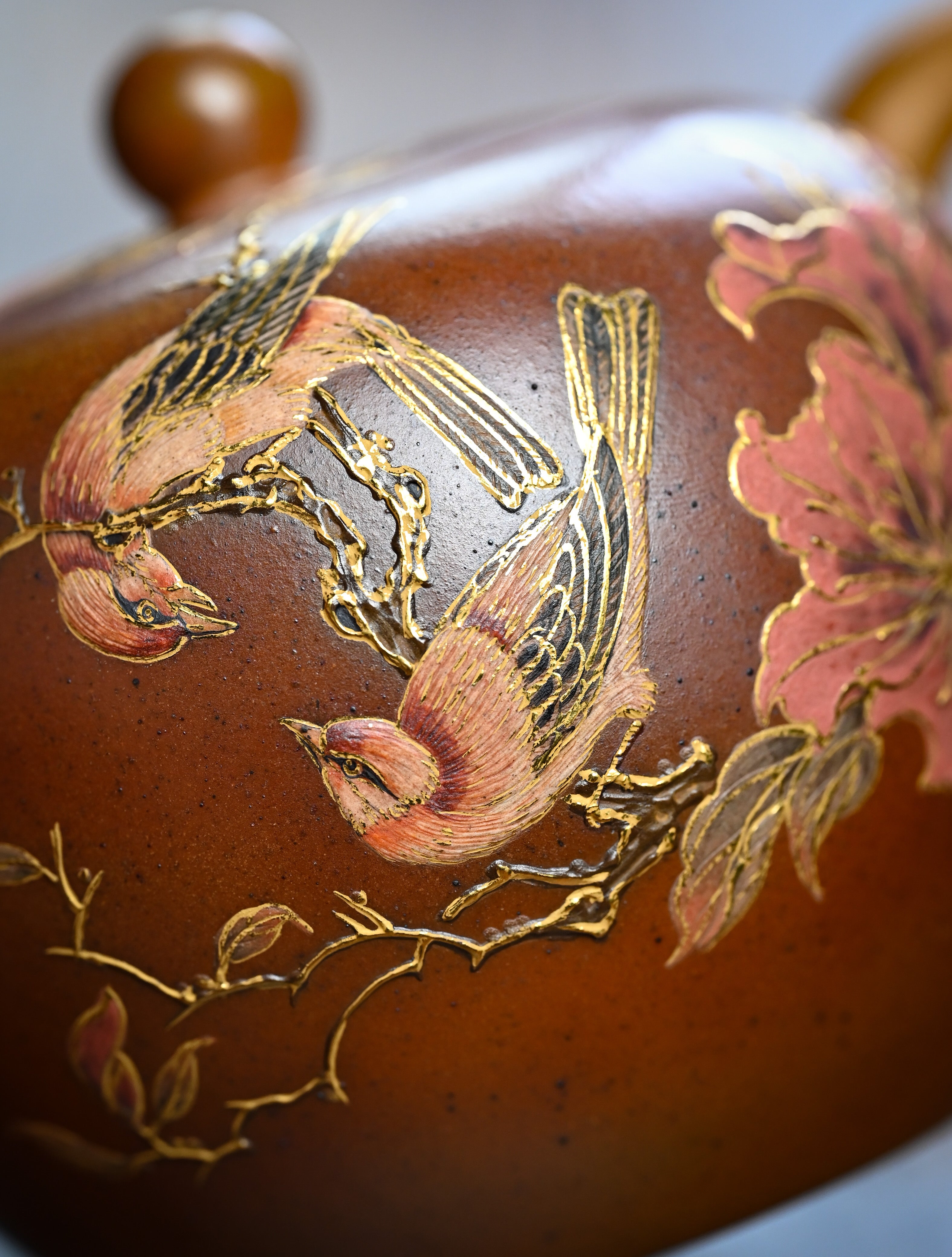 YANYOO handmade wood-fired Yixing teapot featuring hand-painted floral-and-bird motif, lifestyle detail.