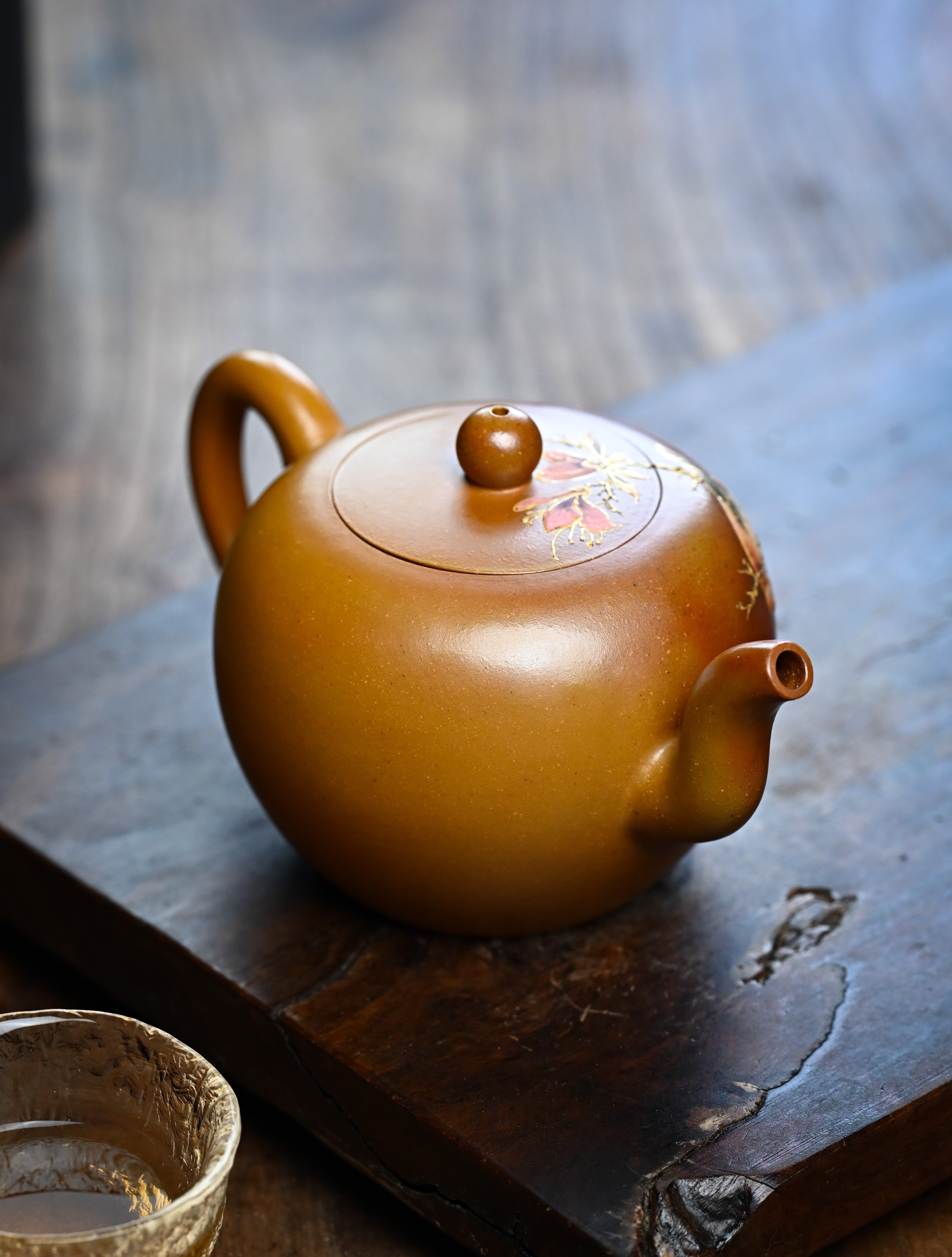 YANYOO handmade wood-fired Yixing teapot featuring hand-painted floral-and-bird motif, lifestyle right side.