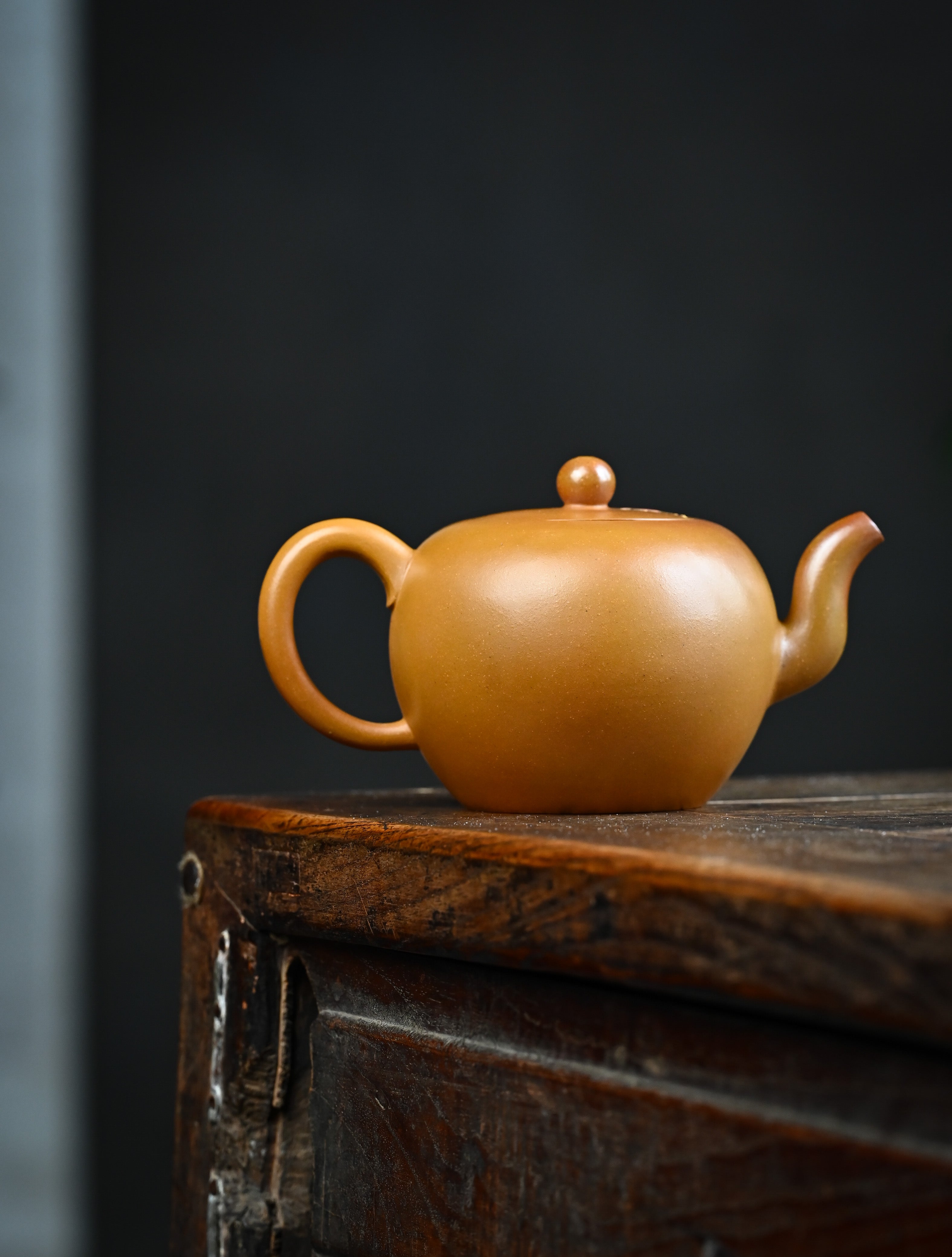 YANYOO handmade wood-fired Yixing teapot featuring hand-painted floral-and-bird motif, lifestyle wide-angle right side.
