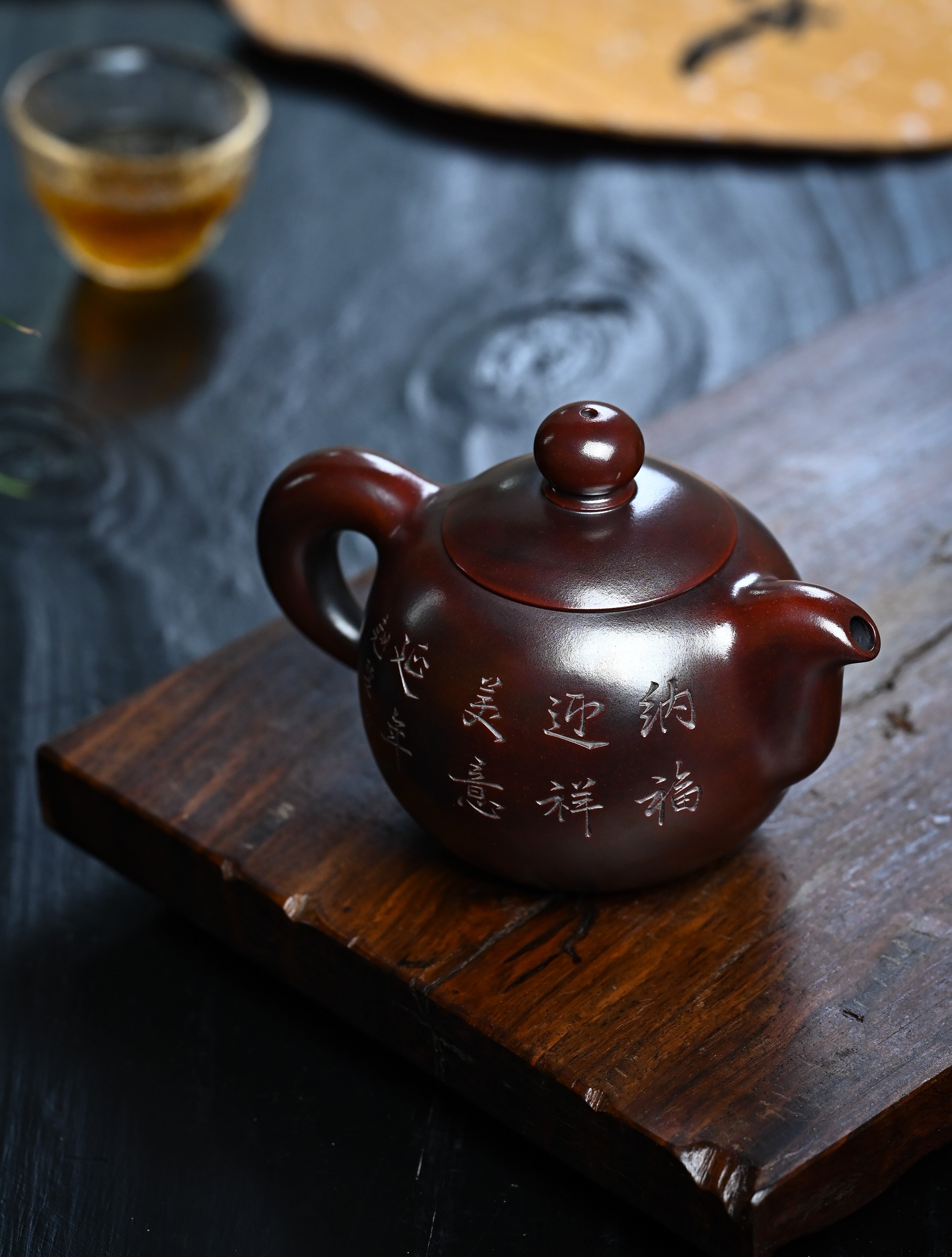 YANYOO handmade Yixing teapot featuring aged Wuni clay and intricate engravings, lifestyle right side.