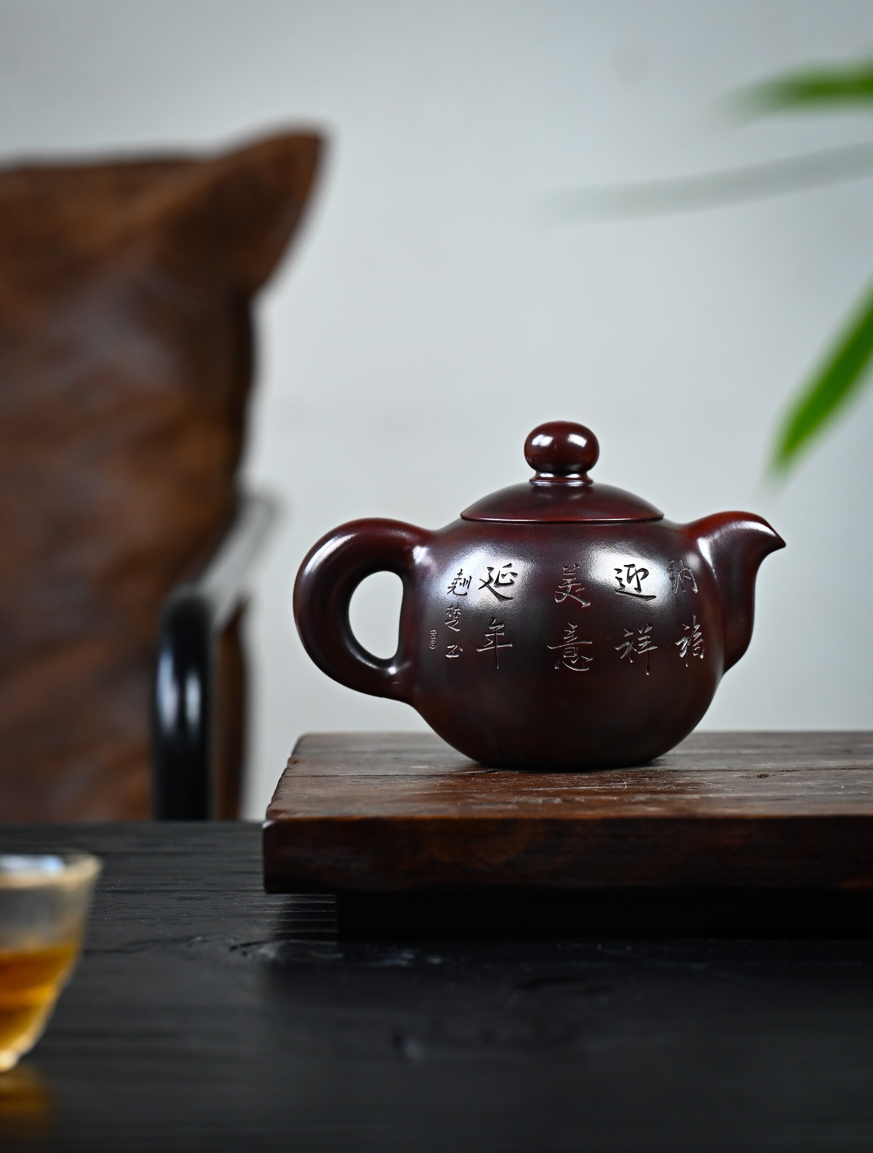 YANYOO handmade Yixing teapot featuring aged Wuni clay and intricate engravings, lifestyle wide-angle right side.