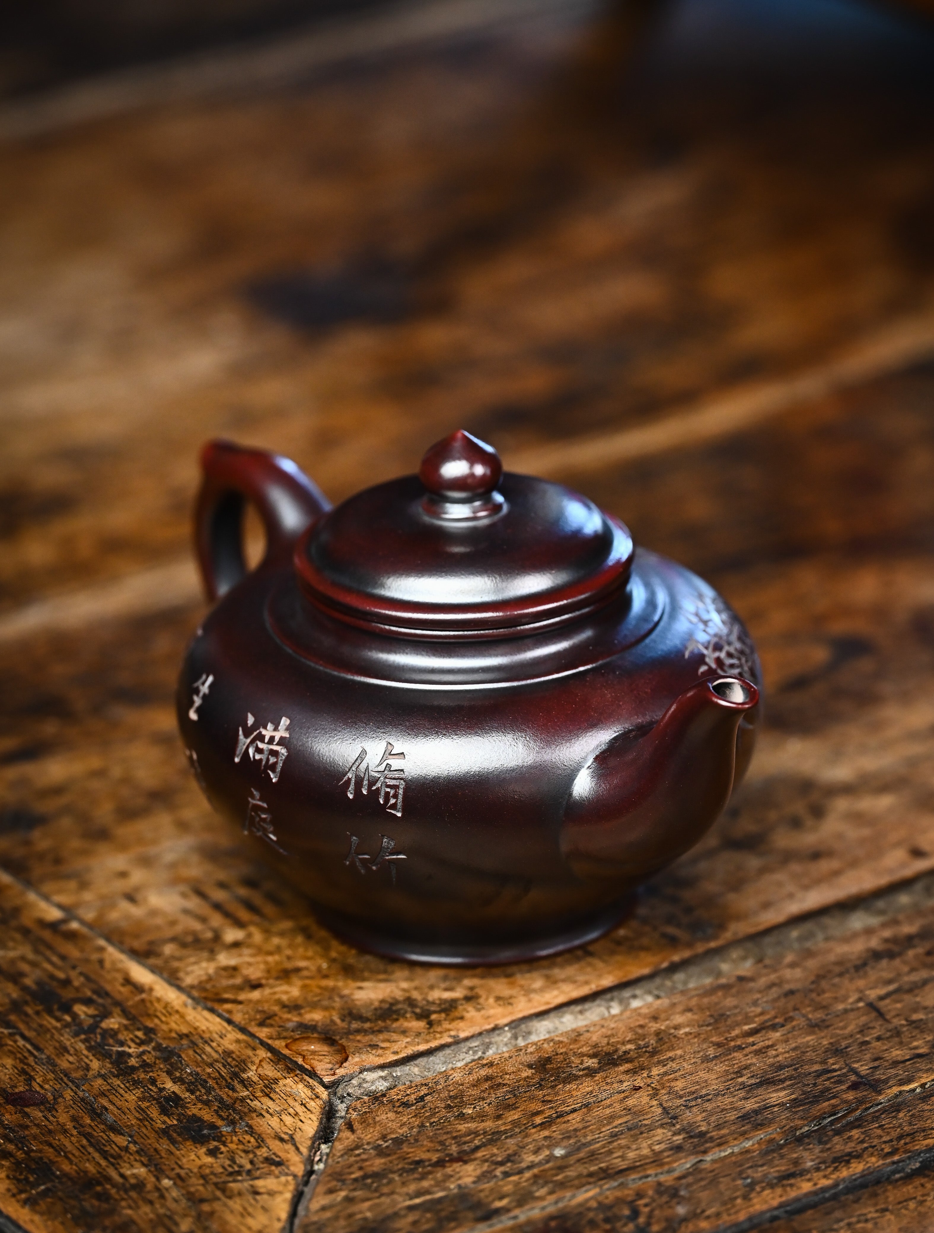 YANYOO handmade Yixing teapot featuring aged Wuni clay and bird engravings, lifestyle right side.