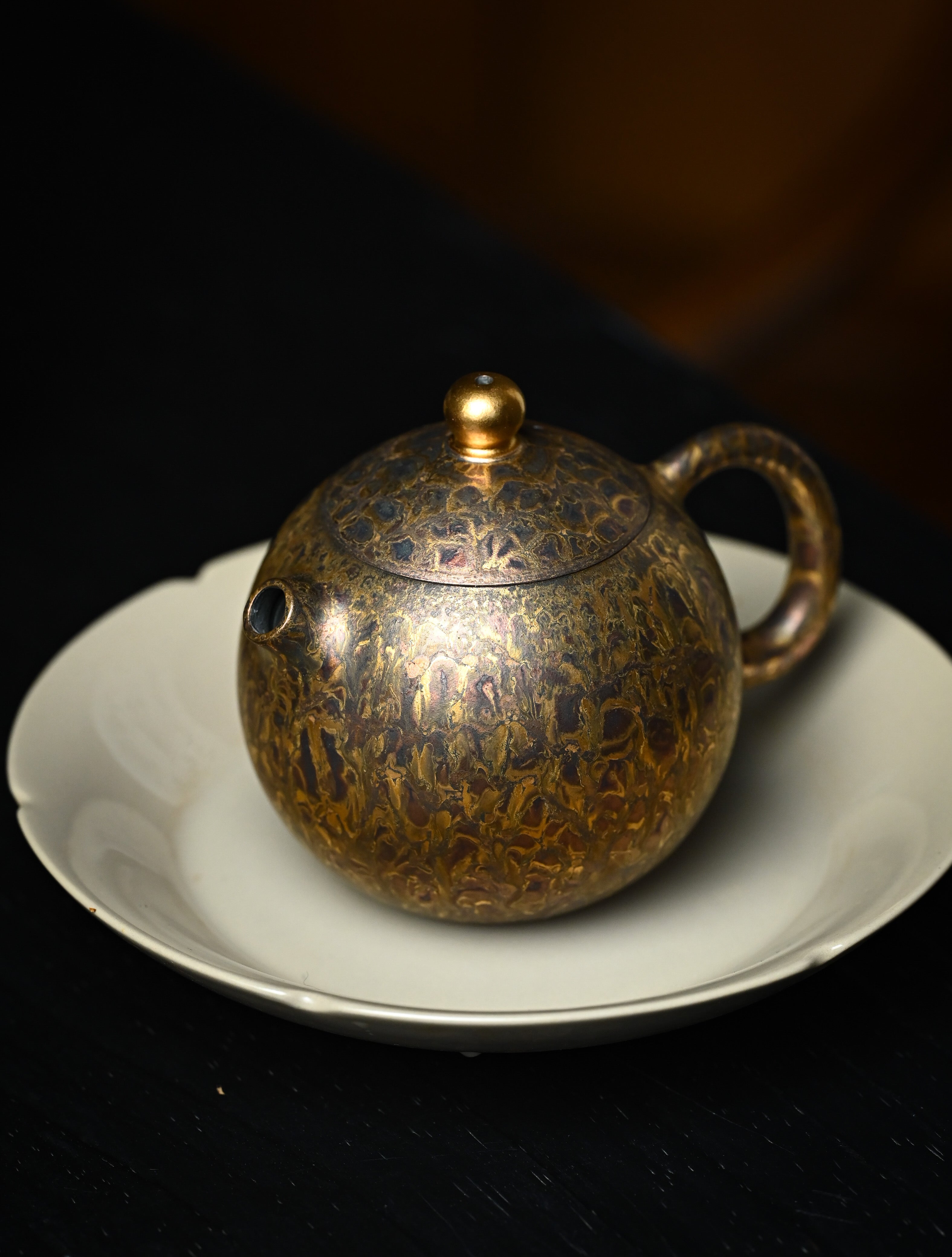 YANYOO handmade Yixing teapot featuring Feather-Plume firing technique, Dragon Egg, lifestyle left side.
