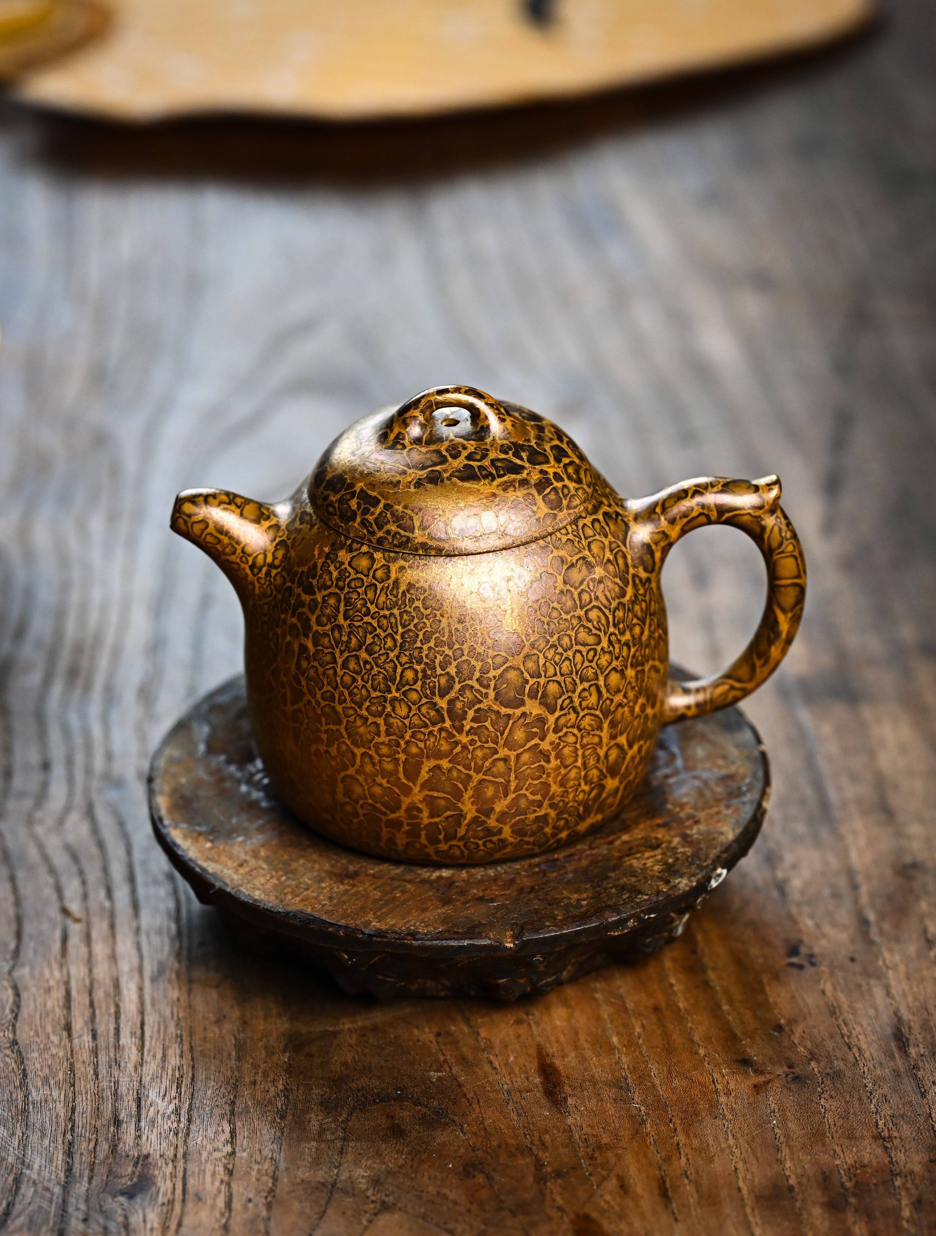 YANYOO handmade Yixing teapot featuring Feather-Plume firing technique, Qin Quan, lifestyle front side.