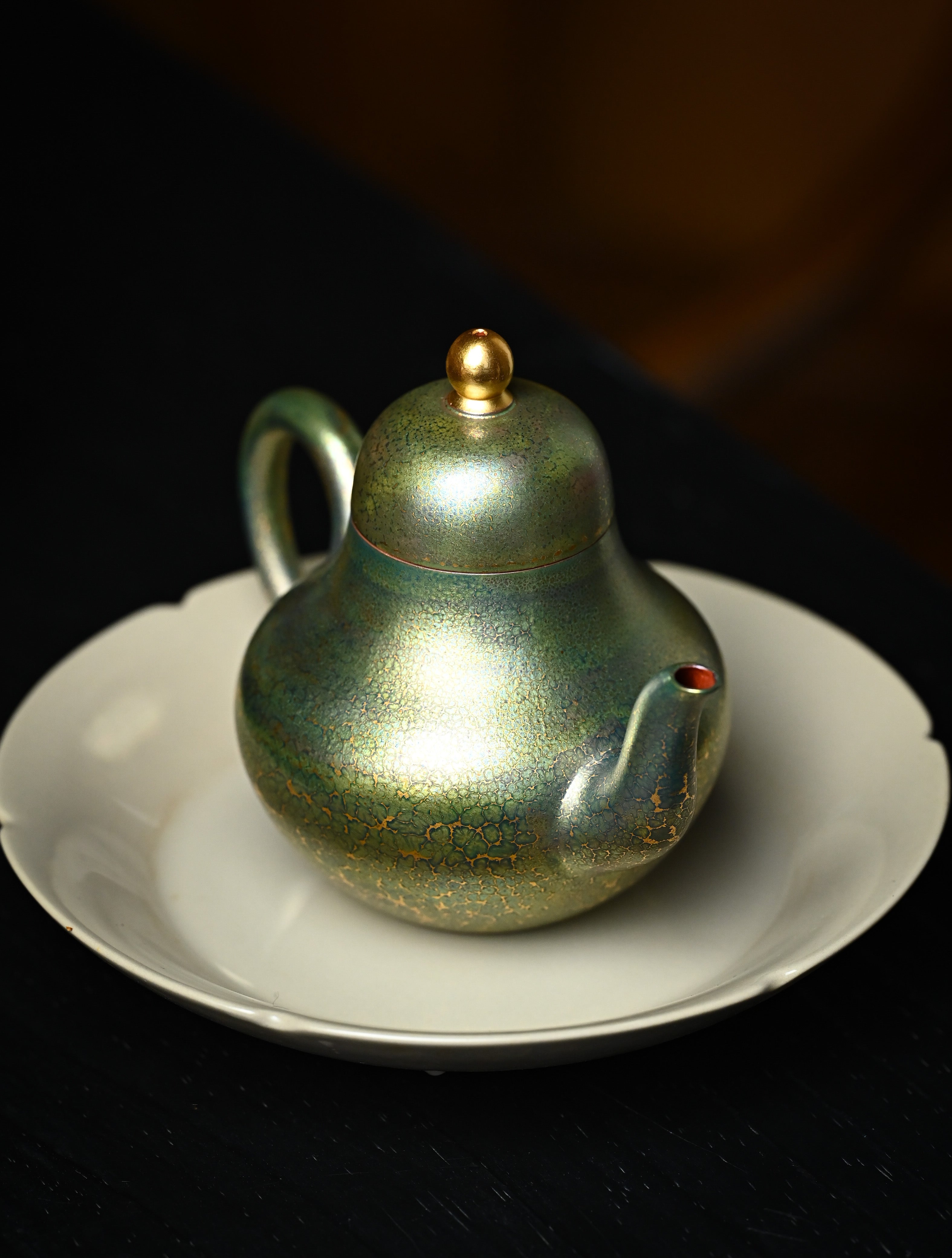 YANYOO handmade Yixing teapot featuring Feather-Plume firing technique, Si Ting green, lifestyle right side.