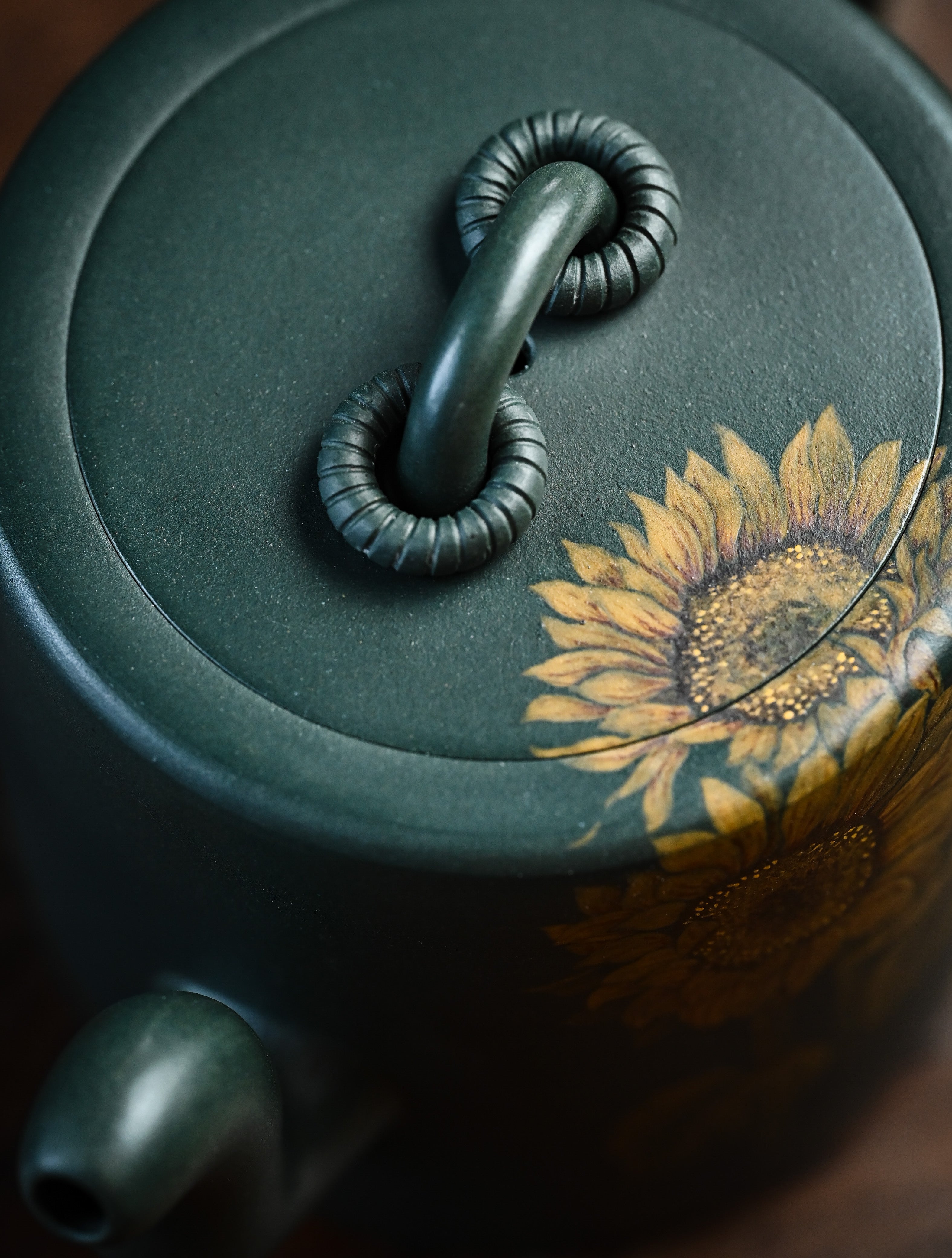 YANYOO handmade Yixing teapot featuring aged green clay and embedded painting of sunflower by Master Xuanzi, lifestyle detail top side.
