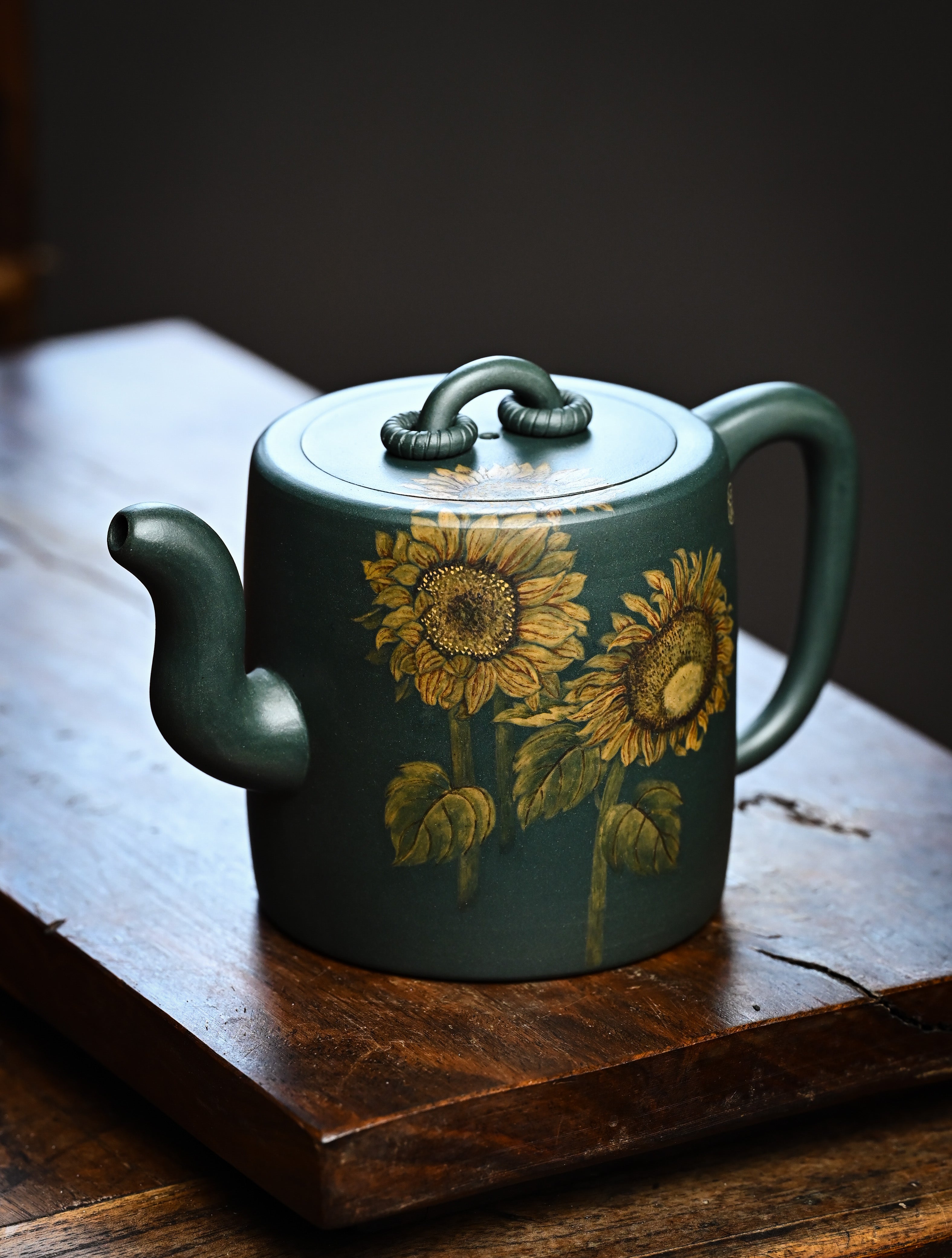 YANYOO handmade Yixing teapot featuring aged green clay and embedded painting of sunflower by Master Xuanzi, lifestyle left side.