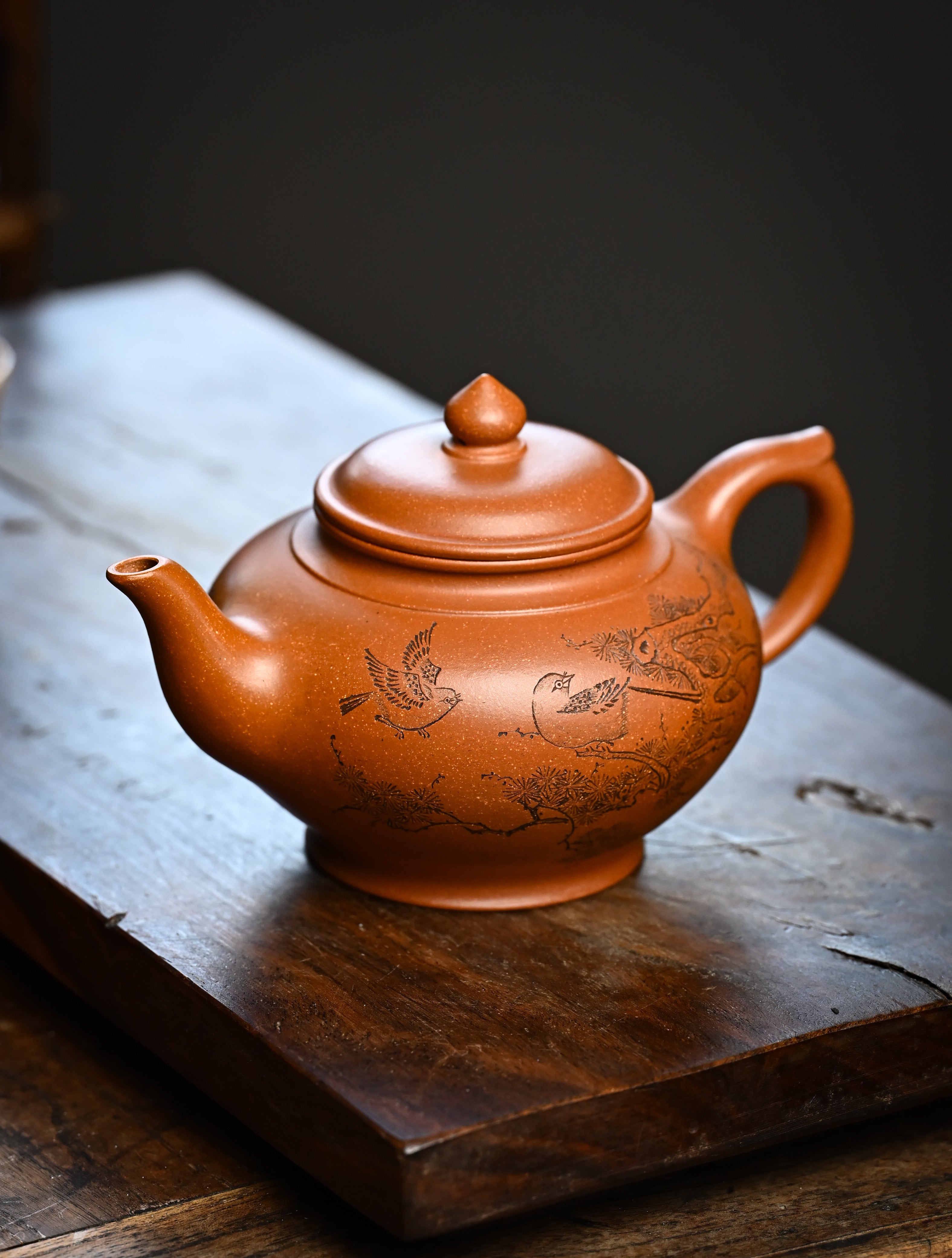 YANYOO handmade Yixing teapot featuring Yucheng Kiln Duanni clay and delicate engravings, Xiao Ying, lifestyle left side.