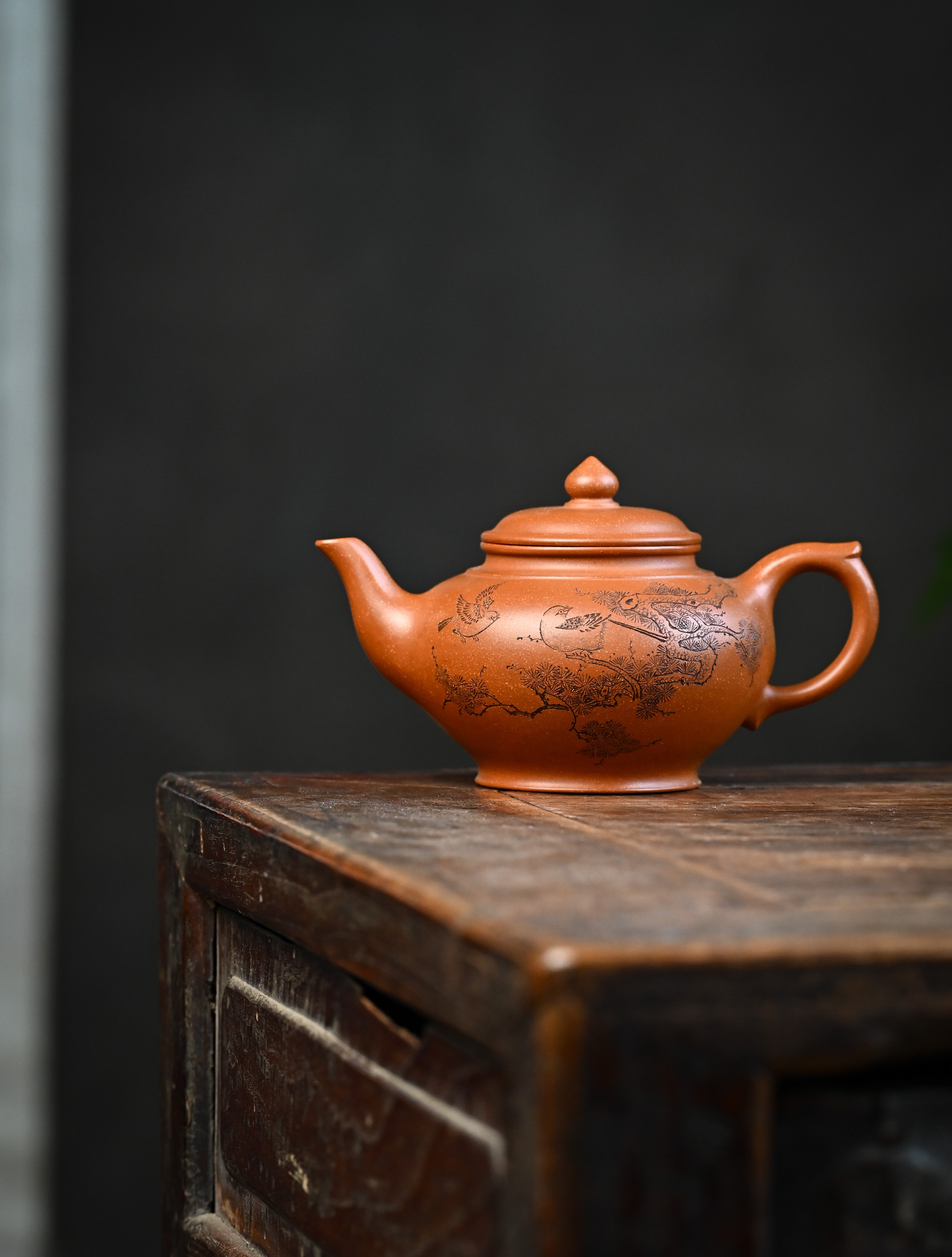 YANYOO handmade Yixing teapot featuring Yucheng Kiln Duanni clay and delicate engravings, Xiao Ying, lifestyle wide-angle left side.