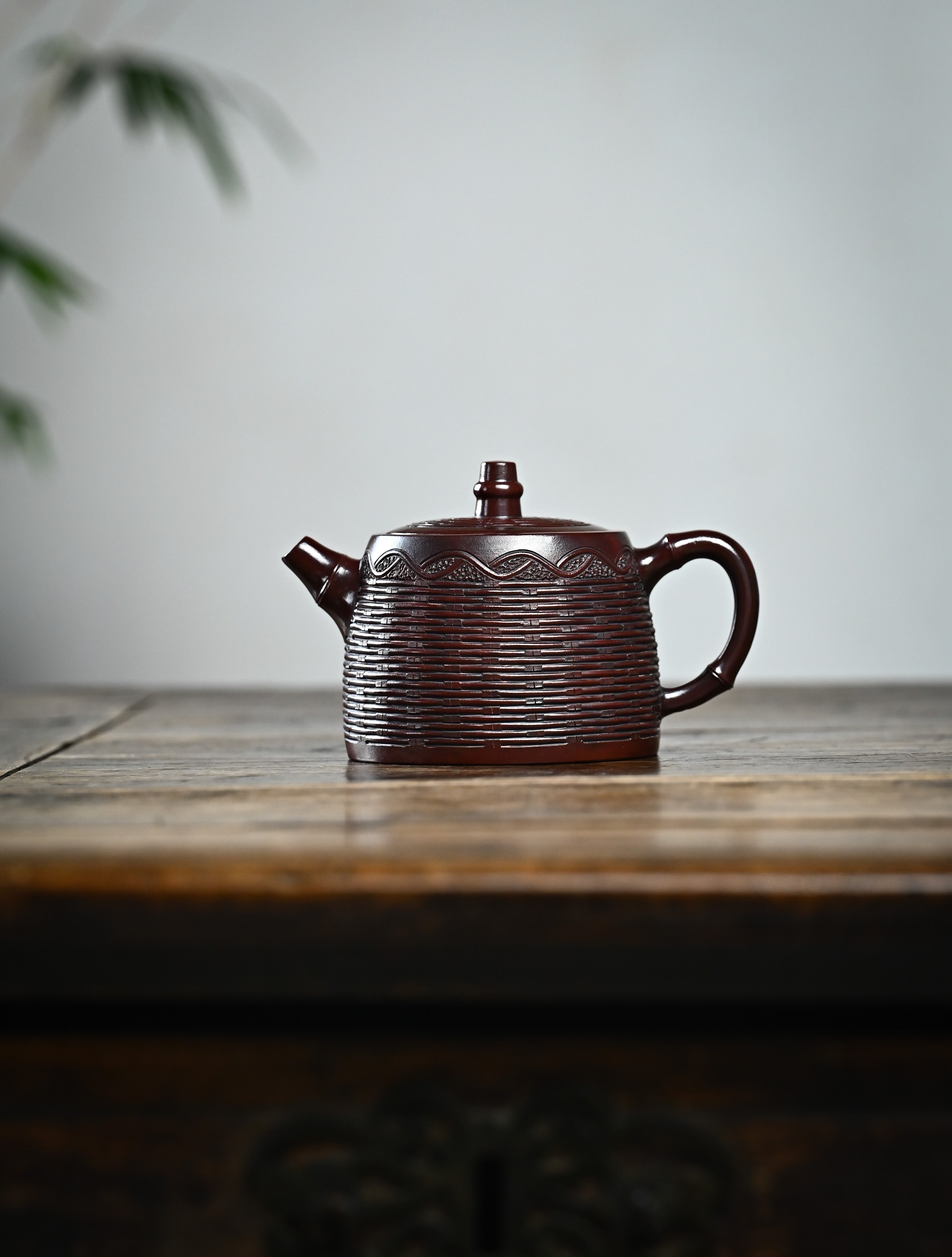 YANYOO handcrafted Yixing teapot featuring aged Wuni clay, bamboo weaving technique, Han Duo, lifestyle wide-angle left side.