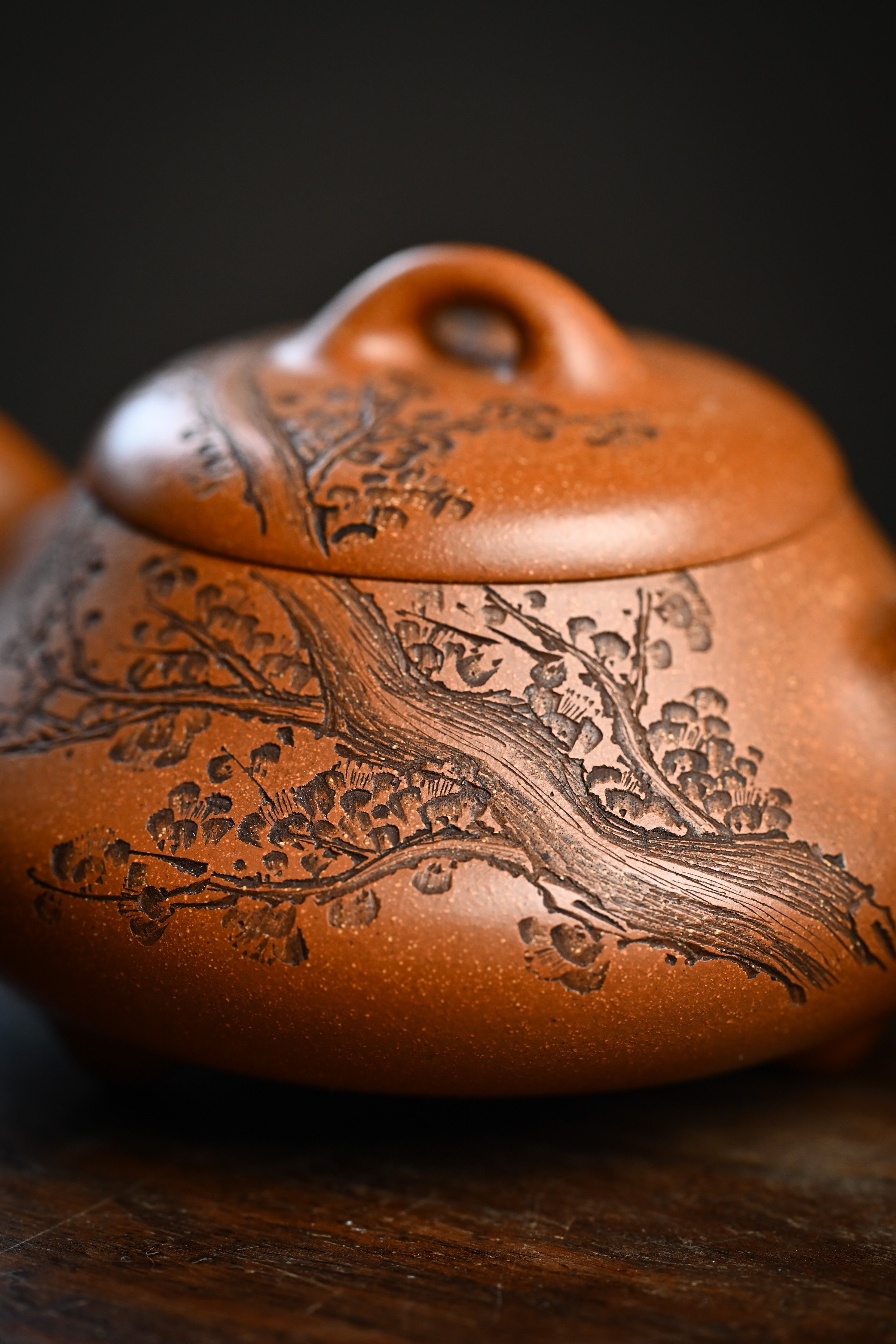 Handmade YANYOO Yixing teapot from Yu Cheng Kiln featuring aged Duanni clay and delicate engraving, lifestyle detail.