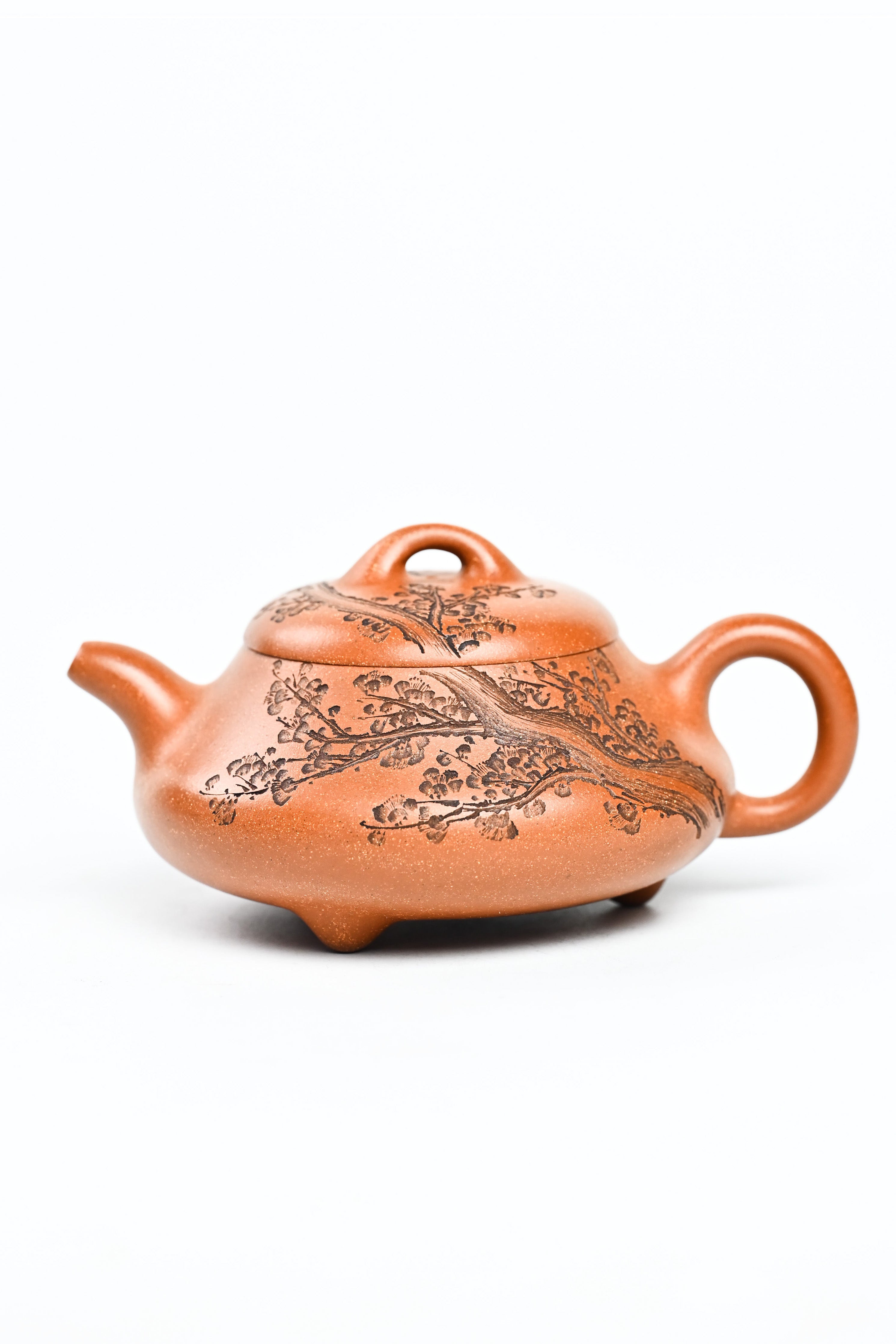 Handmade YANYOO Yixing teapot from Yu Cheng Kiln featuring aged Duanni clay and delicate engraving, product left side.