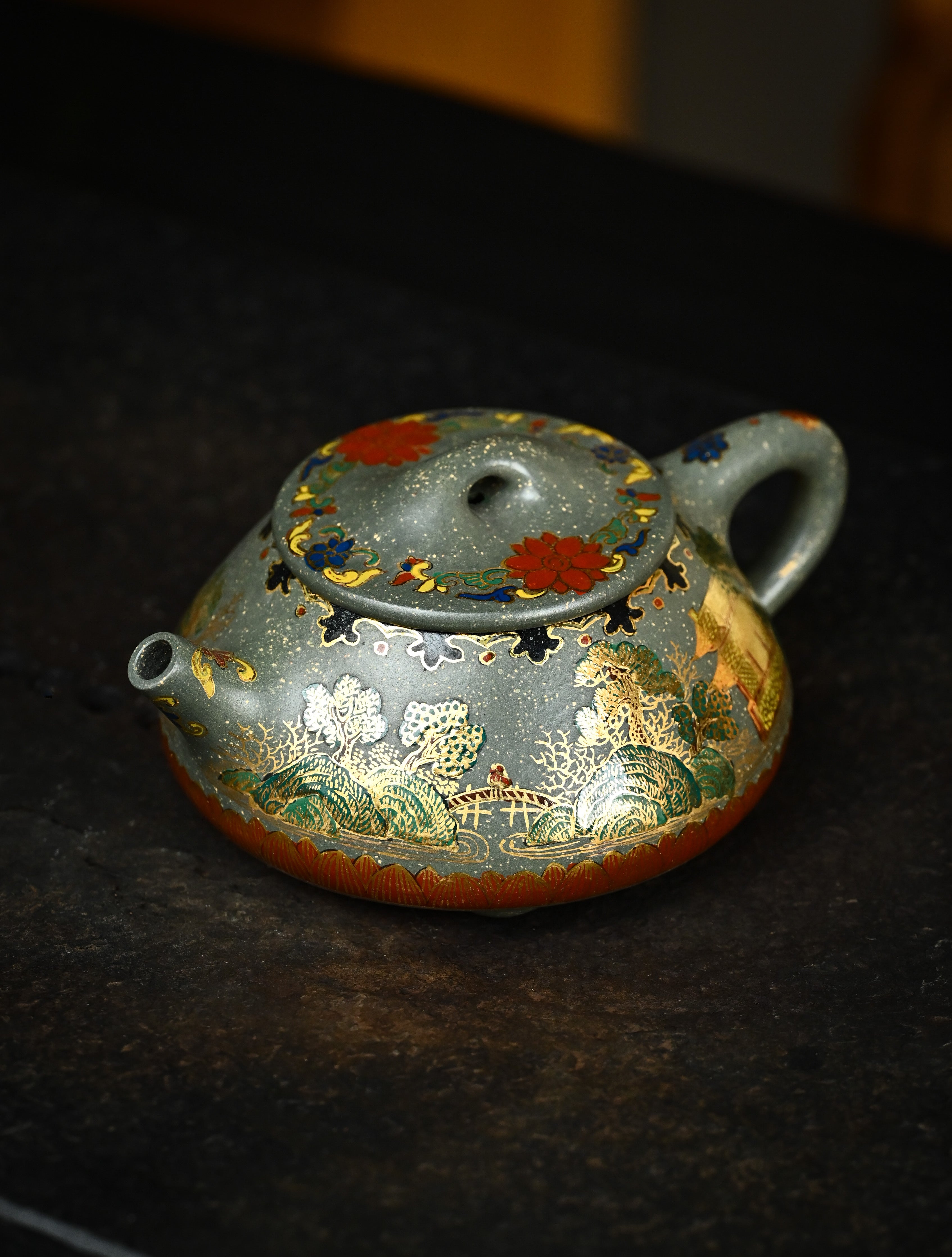 YANYOO handmade Yixing teapot featuring Lvni clay and delicate Falangcai enamel, Jingzhou Shi Piao, lifestyle left side.