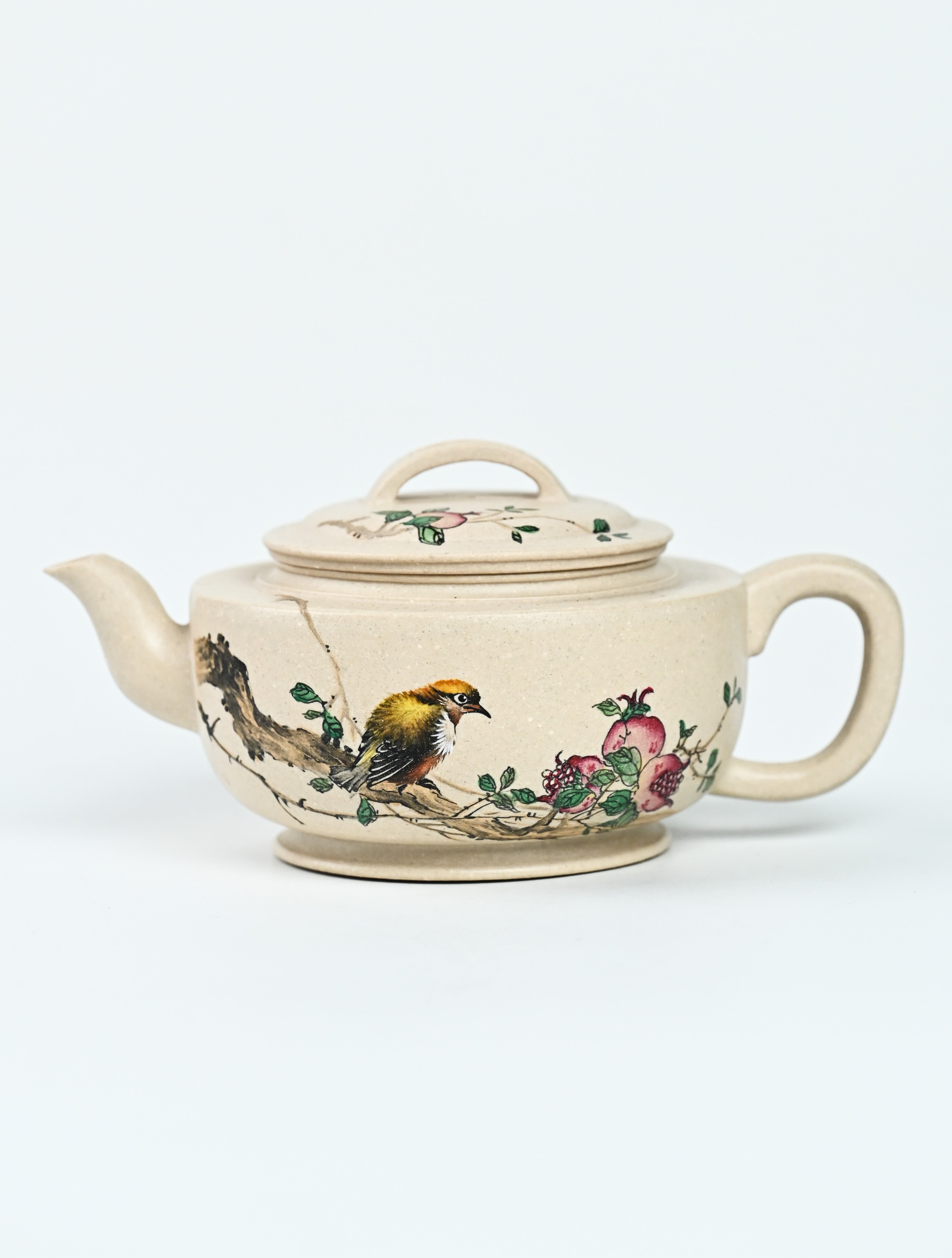 YANYOO handmade Yixing teapot featuring suet white jade Duanni clay and delicate bird-and-pomegranate themed clay painting, Gong Deng, product left side.