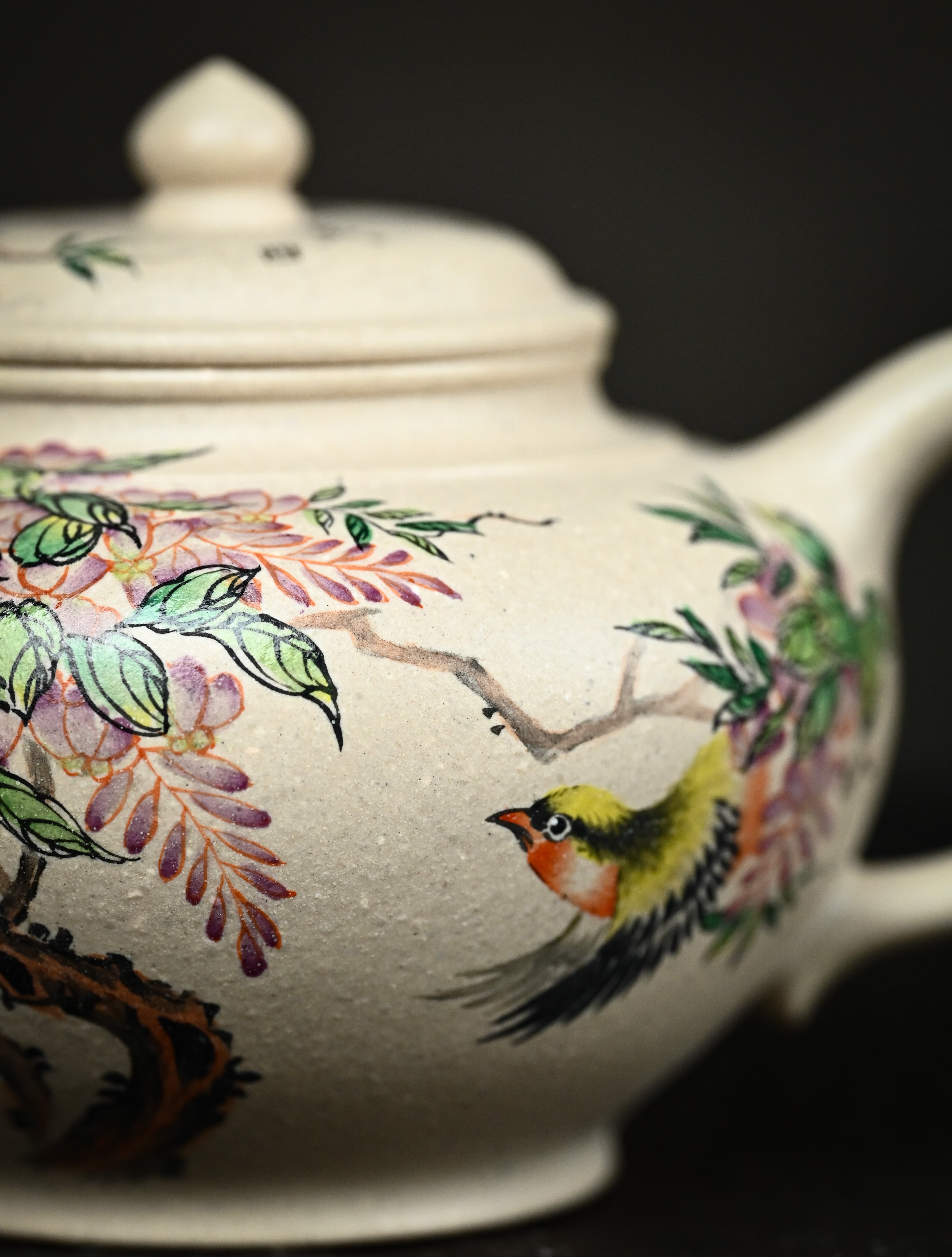 YANYOO handmade Yixing teapot featuring suet white jade Duanni clay and delicate bird-and-peach themed clay painting, Xiao Ying, lifestyle detail front side.