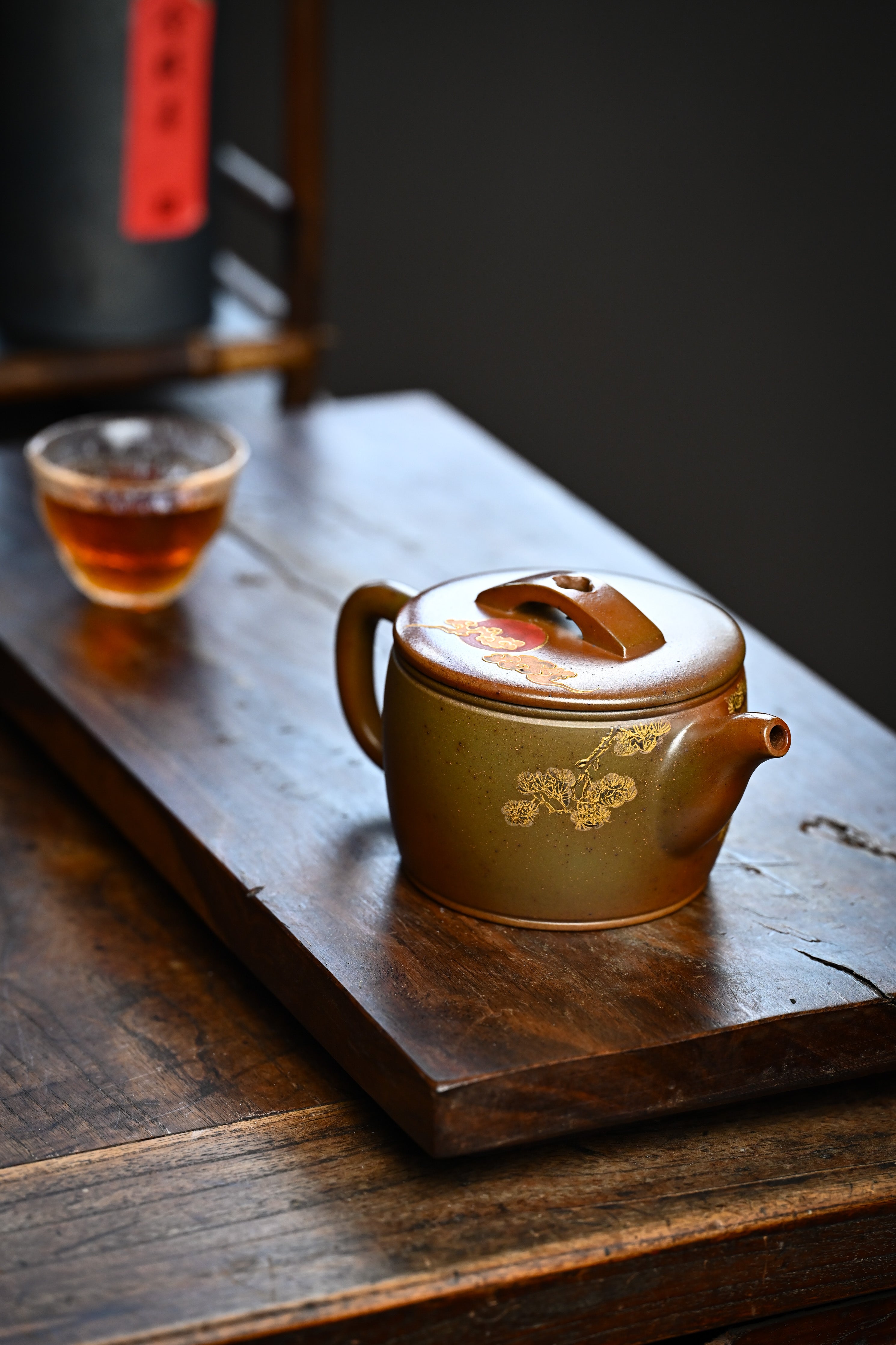 Handmade YANYOO Yixing teapot featuring hand-painted crane and gold enamel, lifestyle right side.