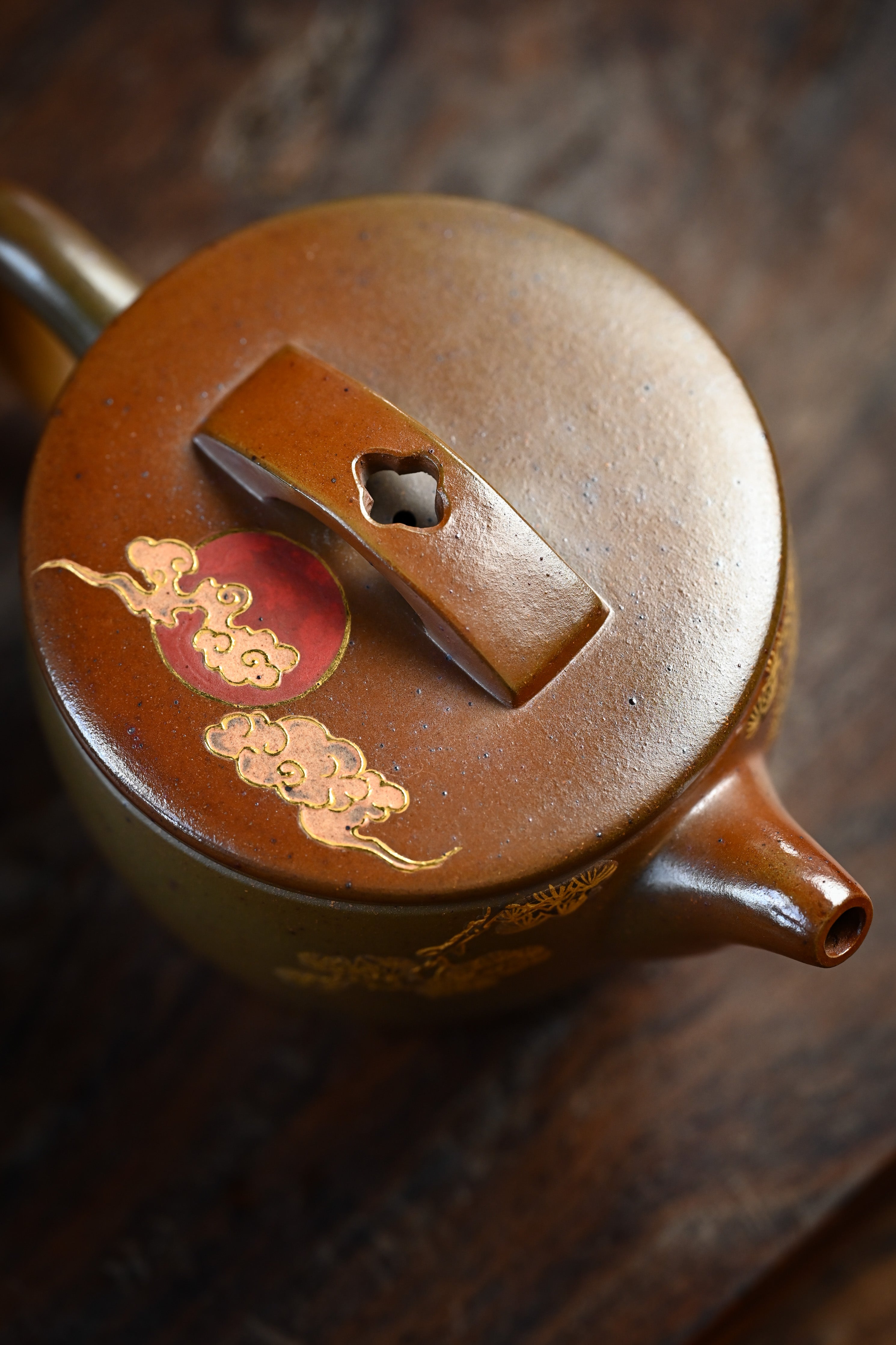 Handmade YANYOO Yixing teapot featuring hand-painted crane and gold enamel, lifestyle top side.