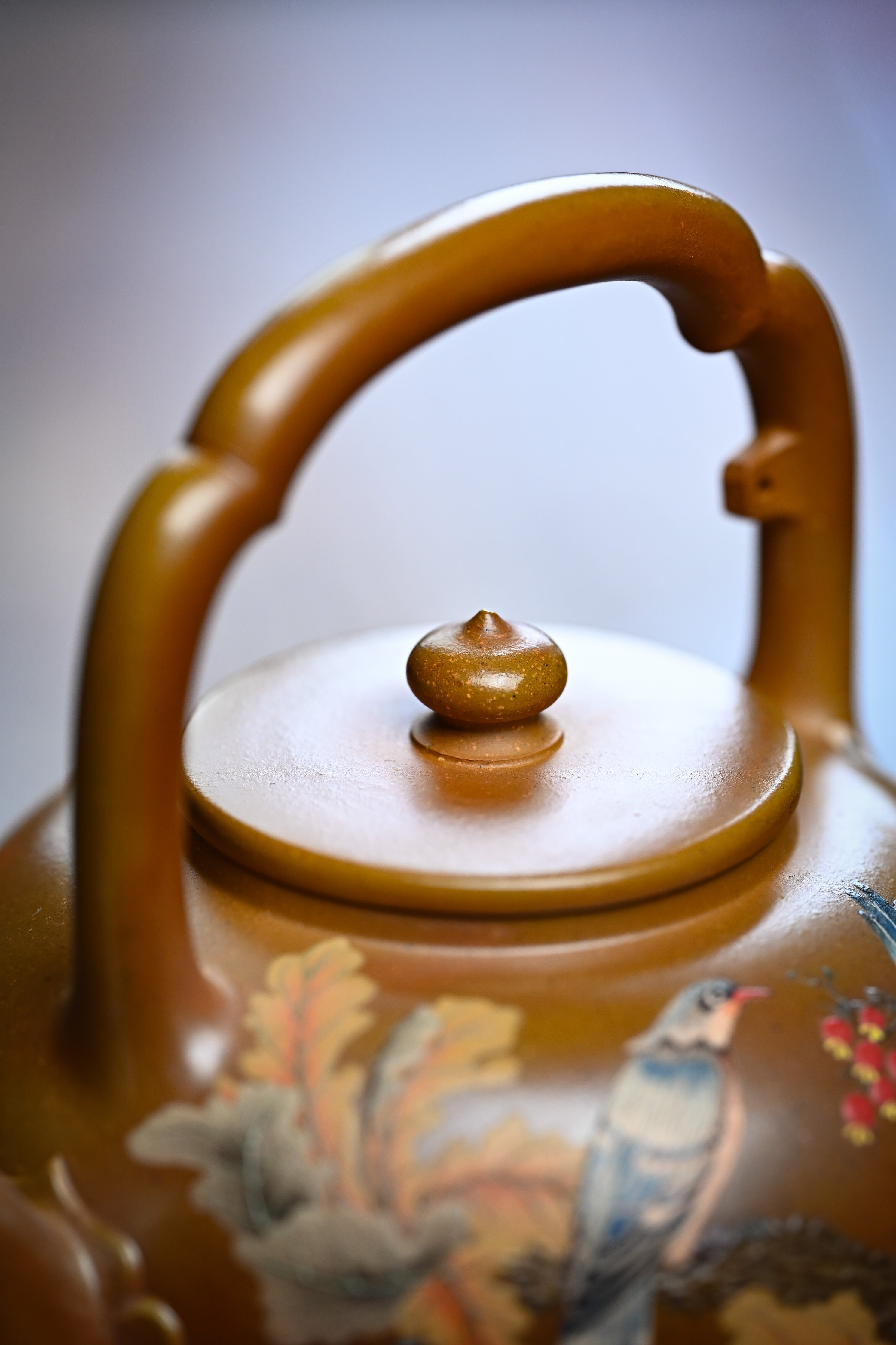 Handmade YANYOO Yixing teapot featuring hand-painted floral and bird motif, lifestyle detail top.