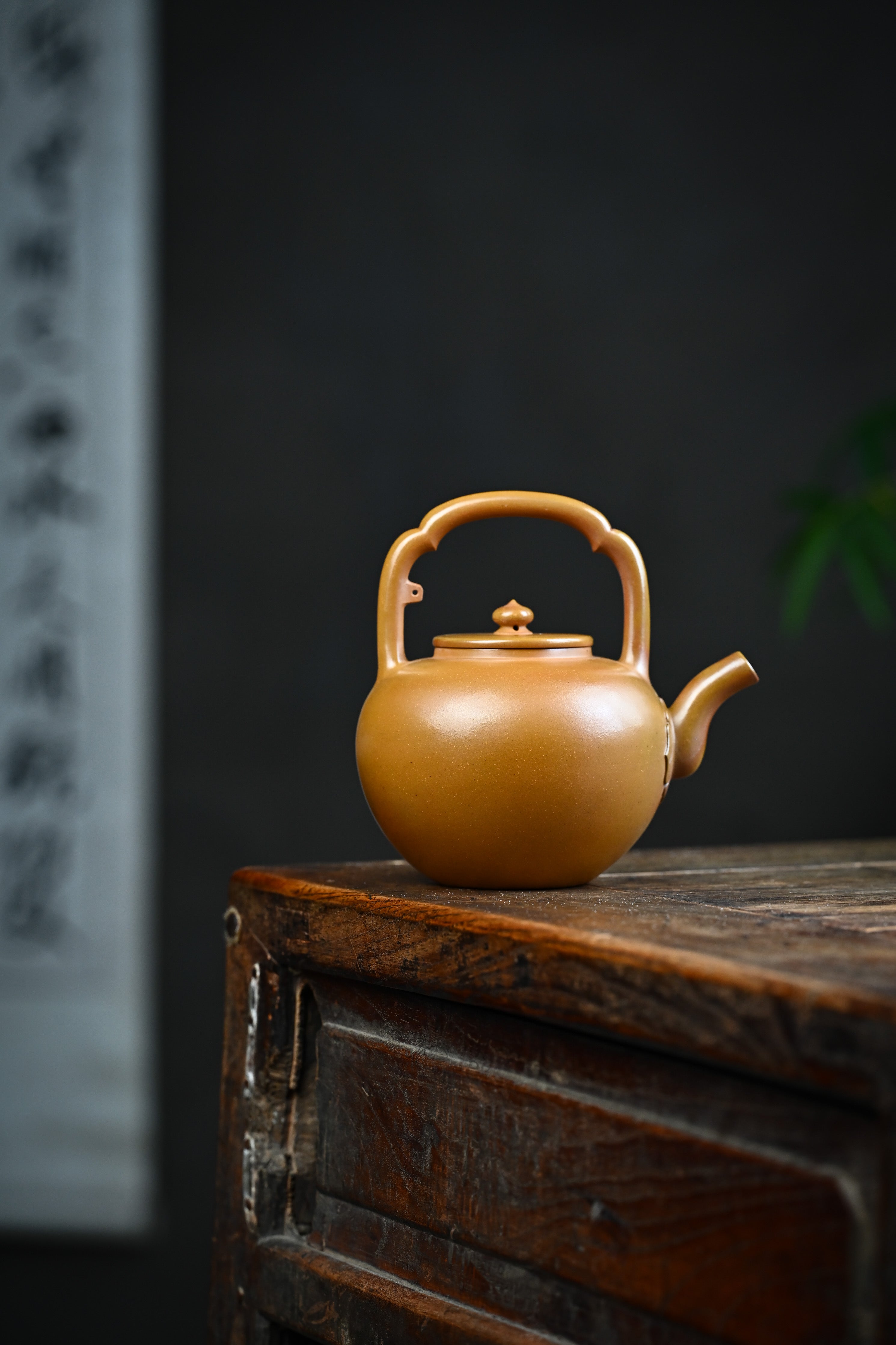 Handmade YANYOO Yixing teapot featuring hand-painted floral and bird motif, lifestyle wide-angle right side.