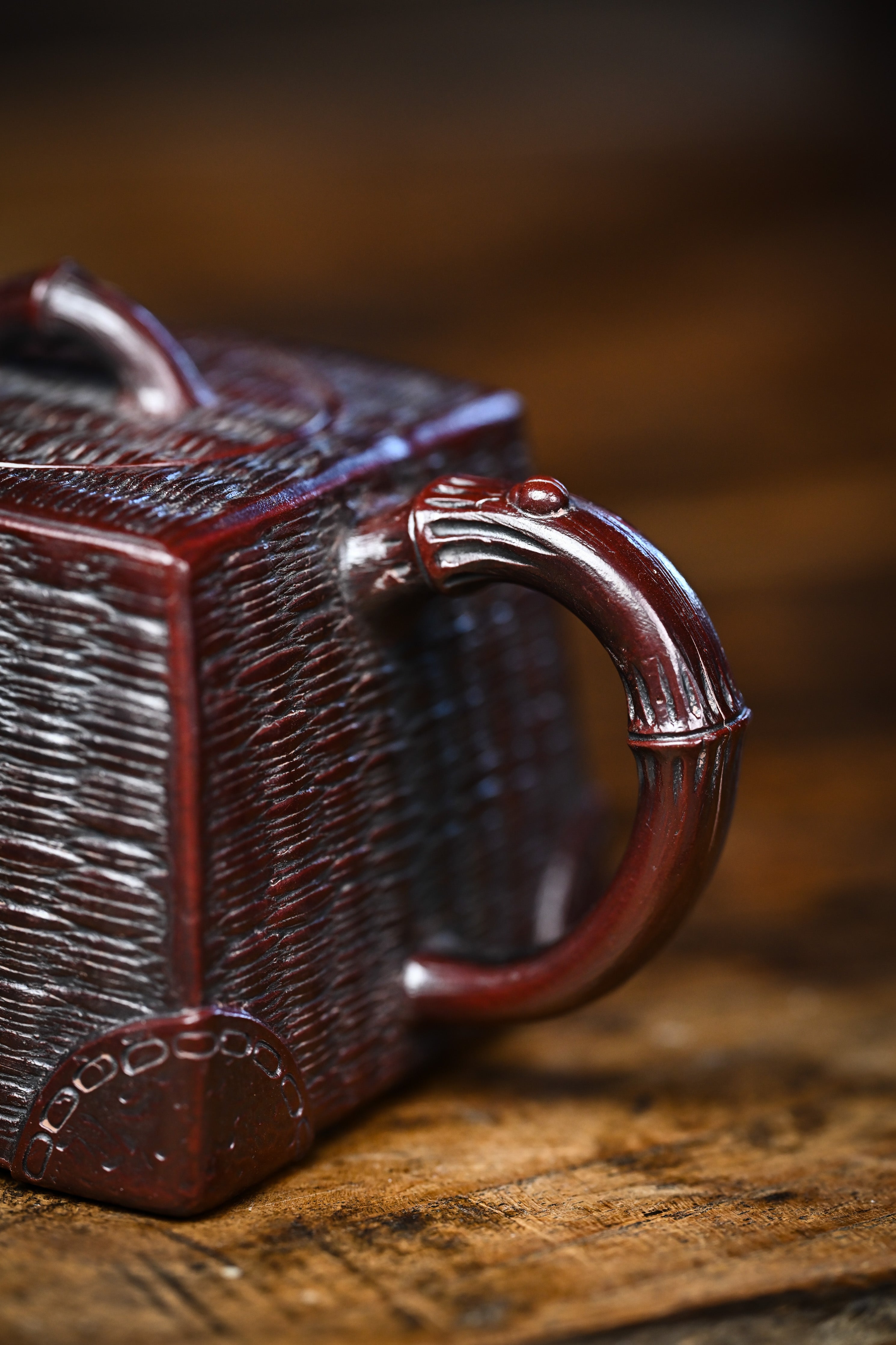 Handcrafted YANYOO Yixing teapot featuring aged Wuni clay and bamboo weaving technique, lifestyle partial detail.