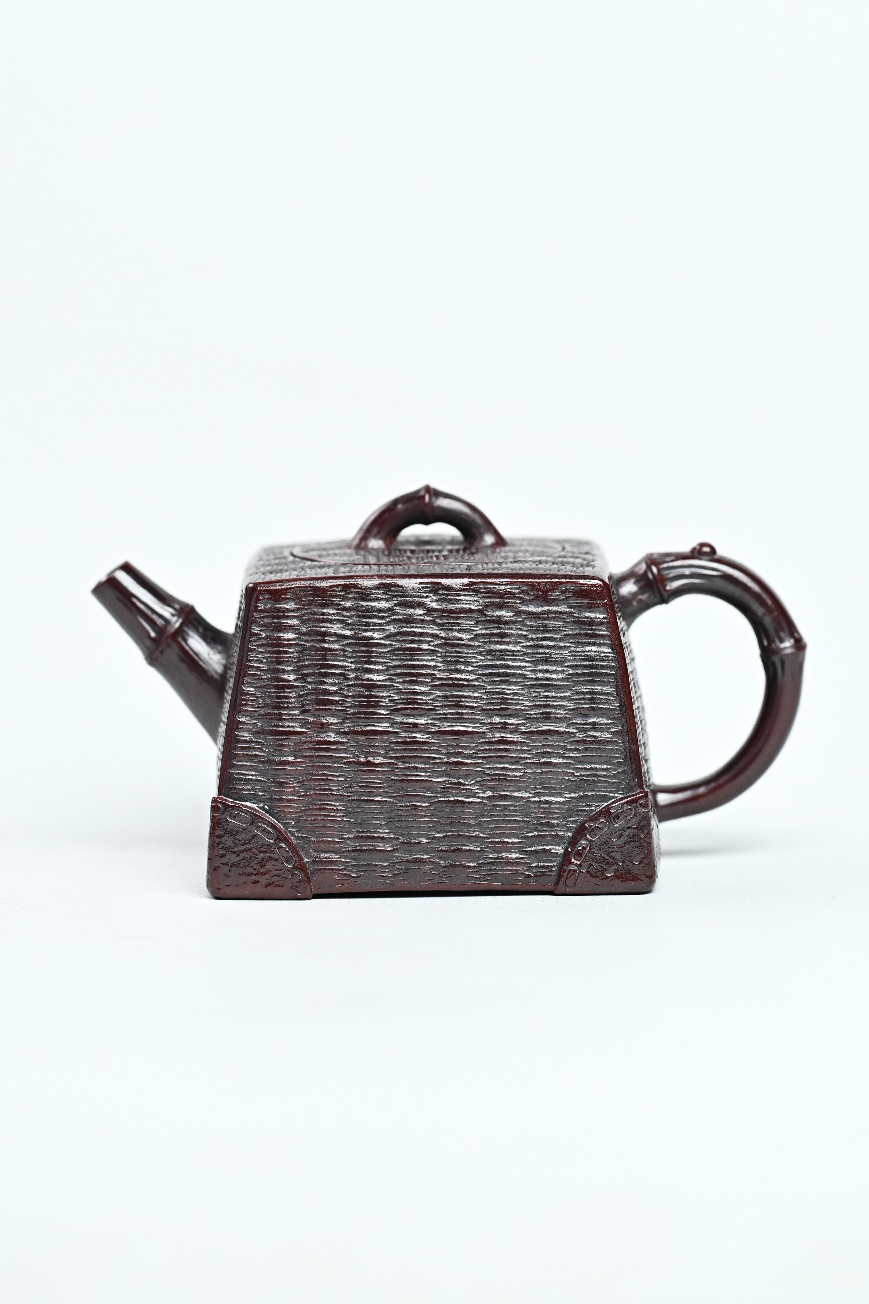 Handcrafted YANYOO Yixing teapot featuring aged Wuni clay and bamboo weaving technique, product left side.