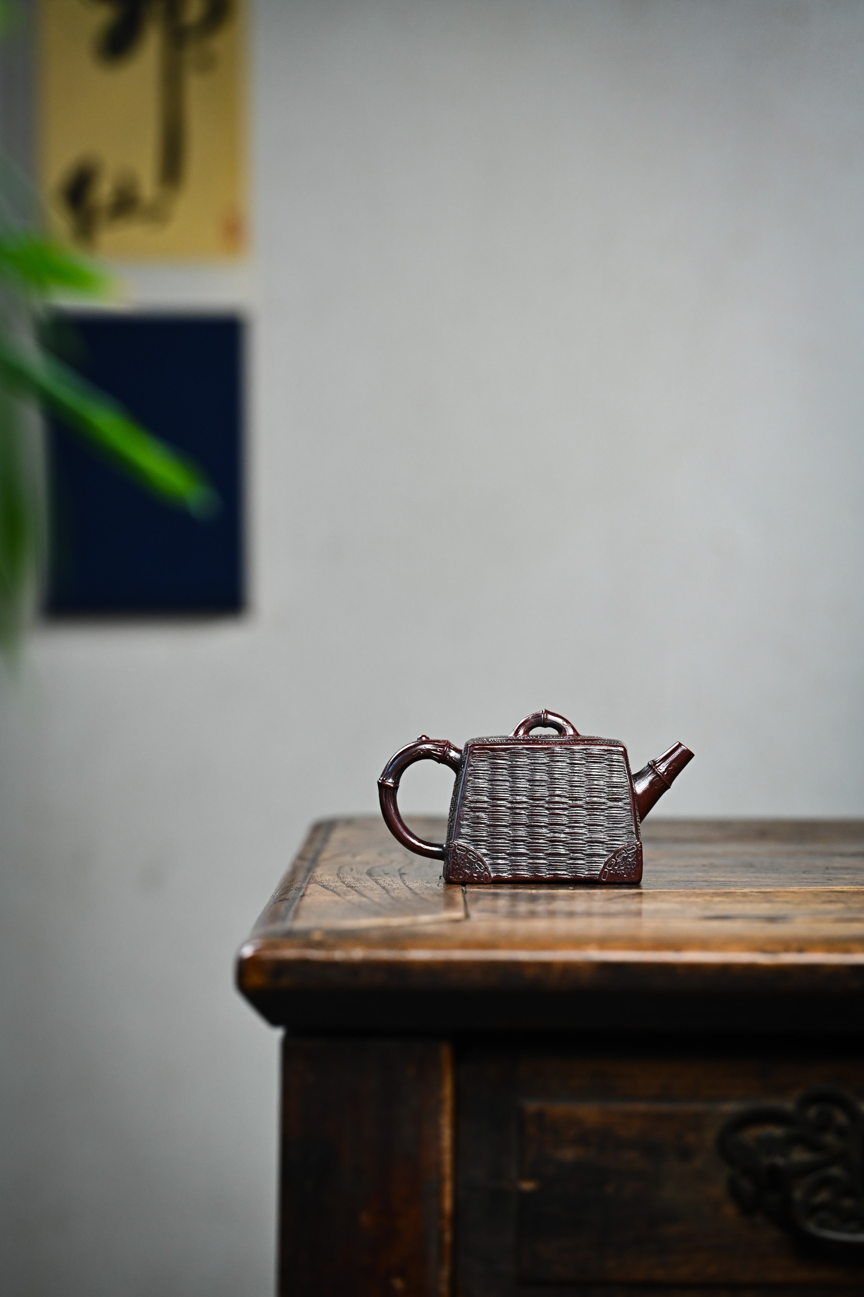 Handcrafted YANYOO Yixing teapot featuring aged Wuni clay and bamboo weaving technique, lifestyle wide-angle right side.