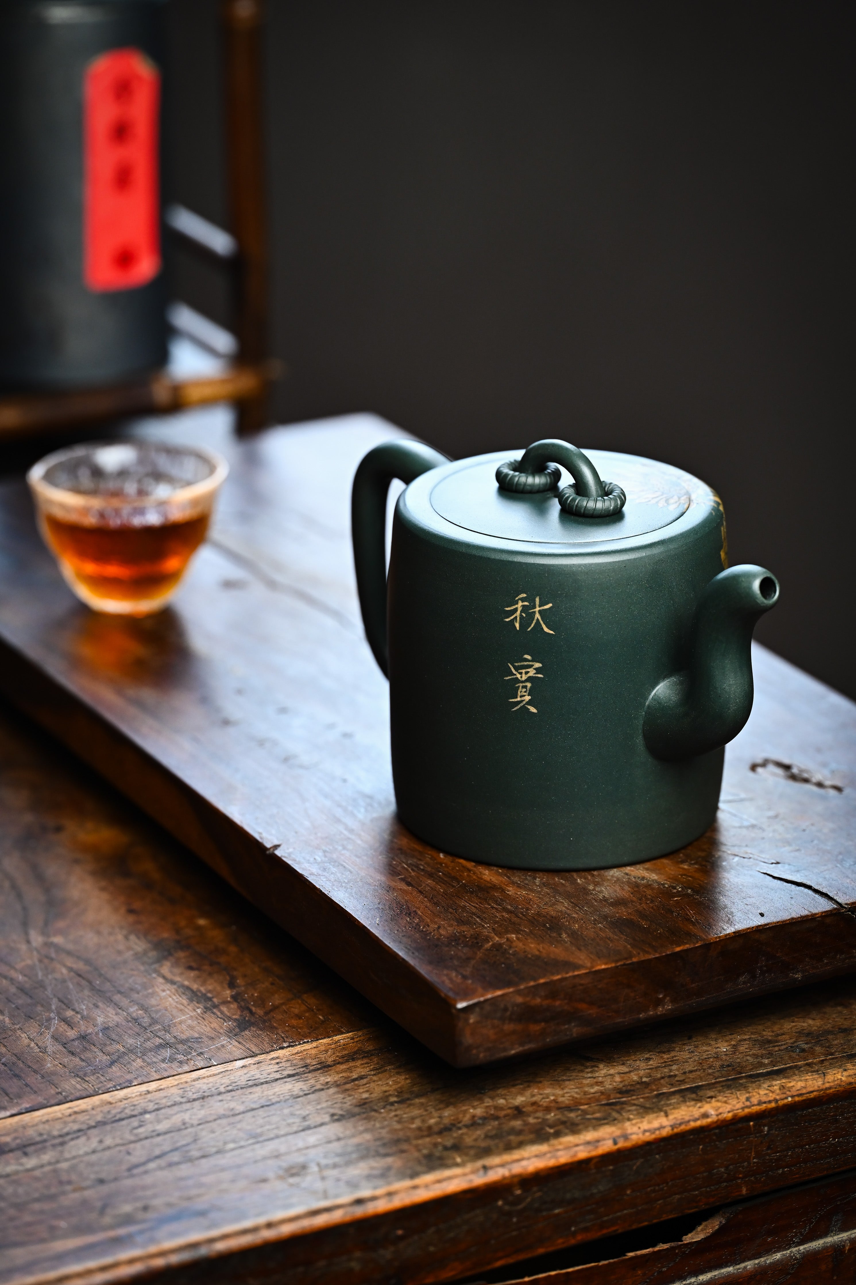 Handmade YANYOO Yixing teapot featuring aged green clay and sunflower design, lifestyle right side.