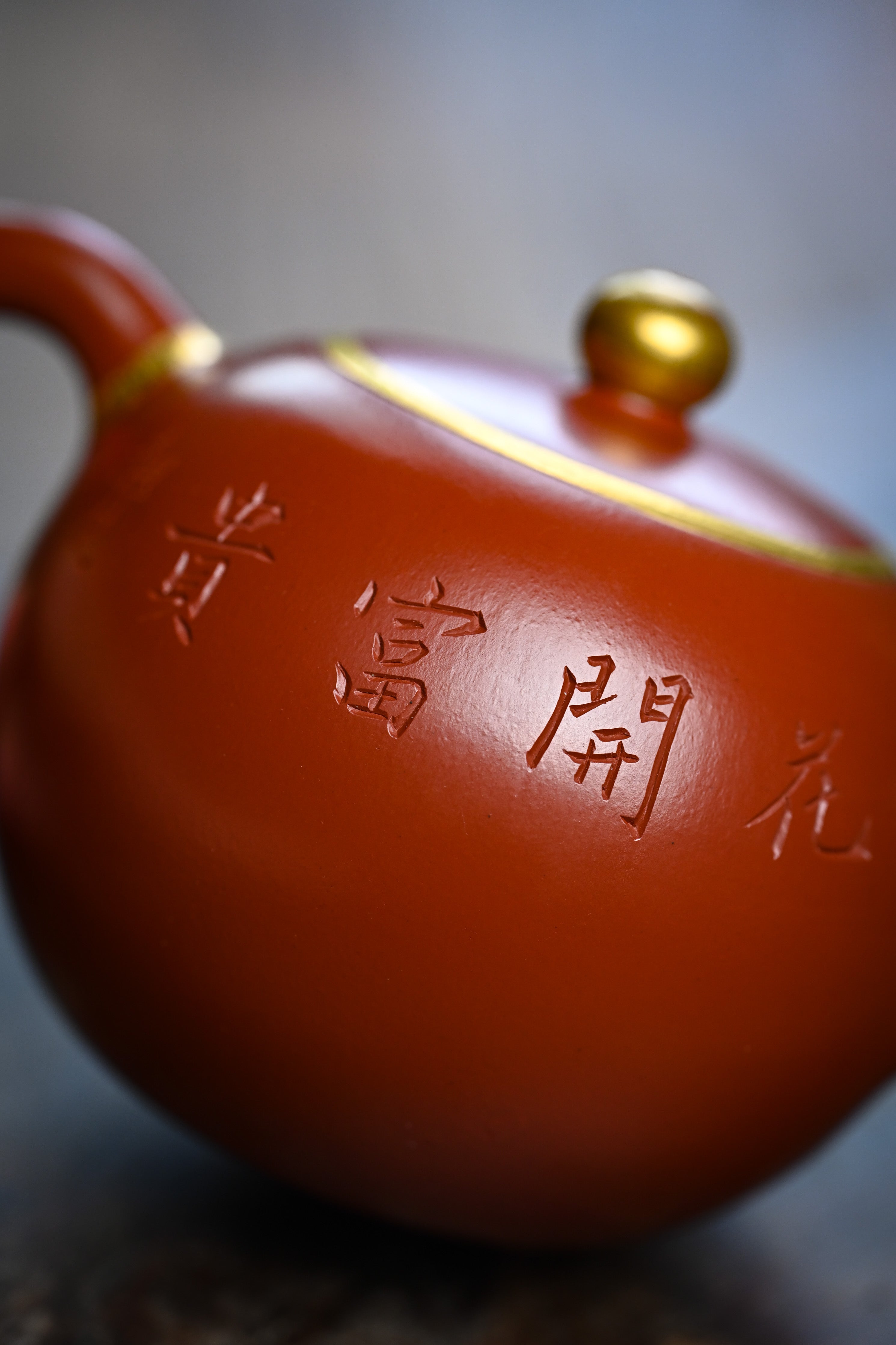 Handmade YANYOO Yixing teapot featuring Zhuni clay and relief engraving, lifestyle detail back.