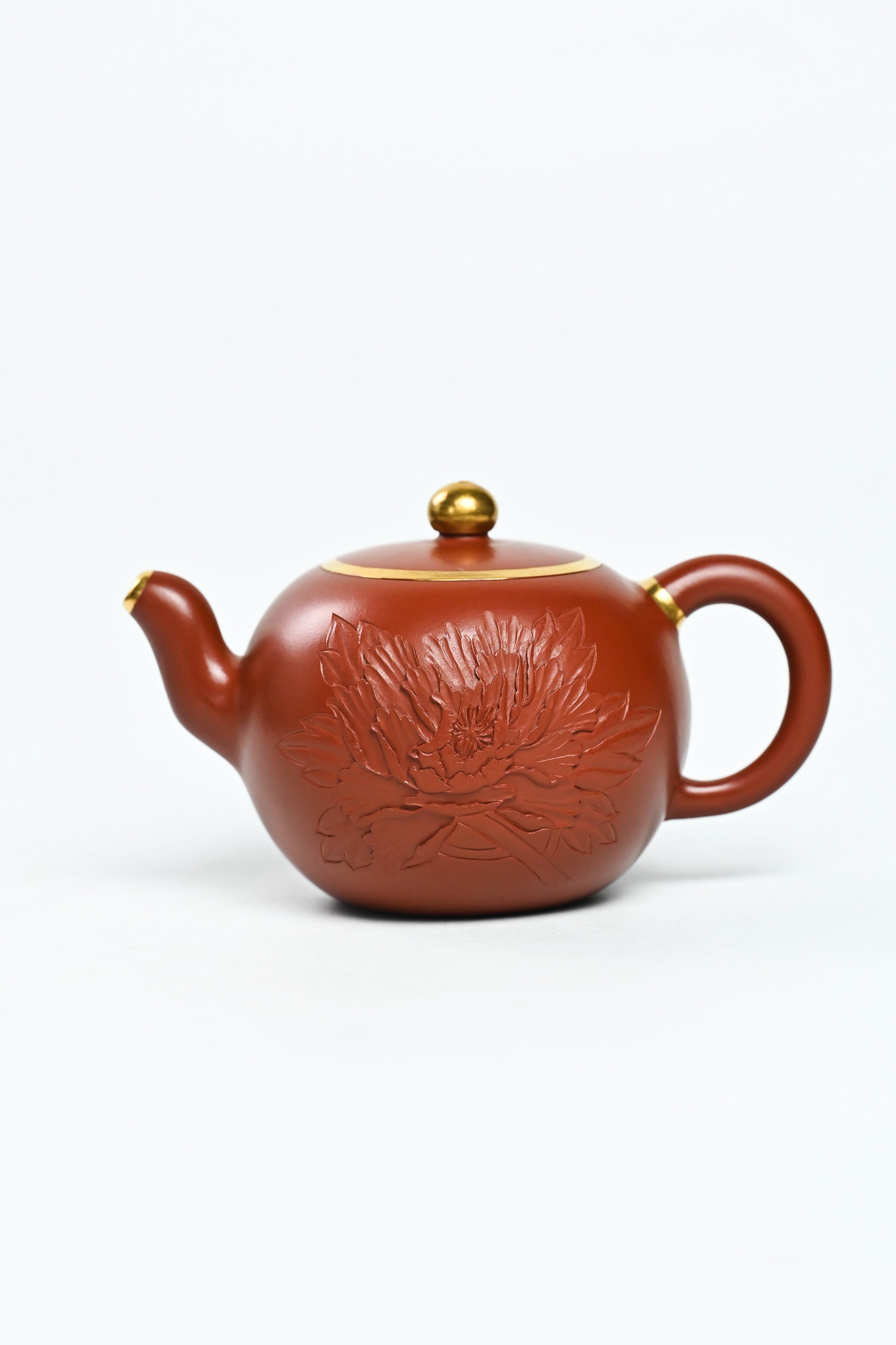 Handmade YANYOO Yixing teapot featuring Zhuni clay and relief engraving, product left side.