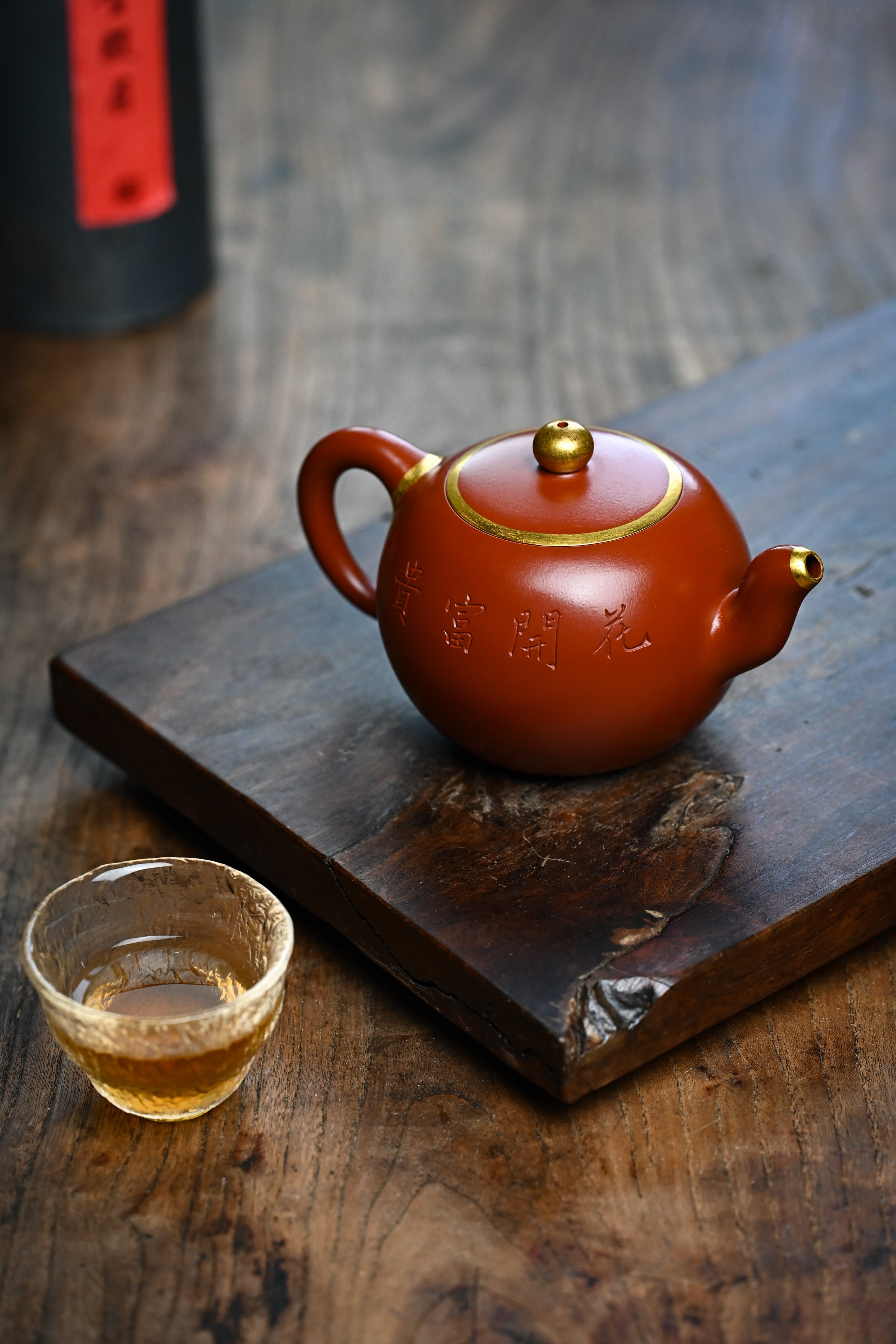 Handmade YANYOO Yixing teapot featuring Zhuni clay and relief engraving, lifestyle right side.