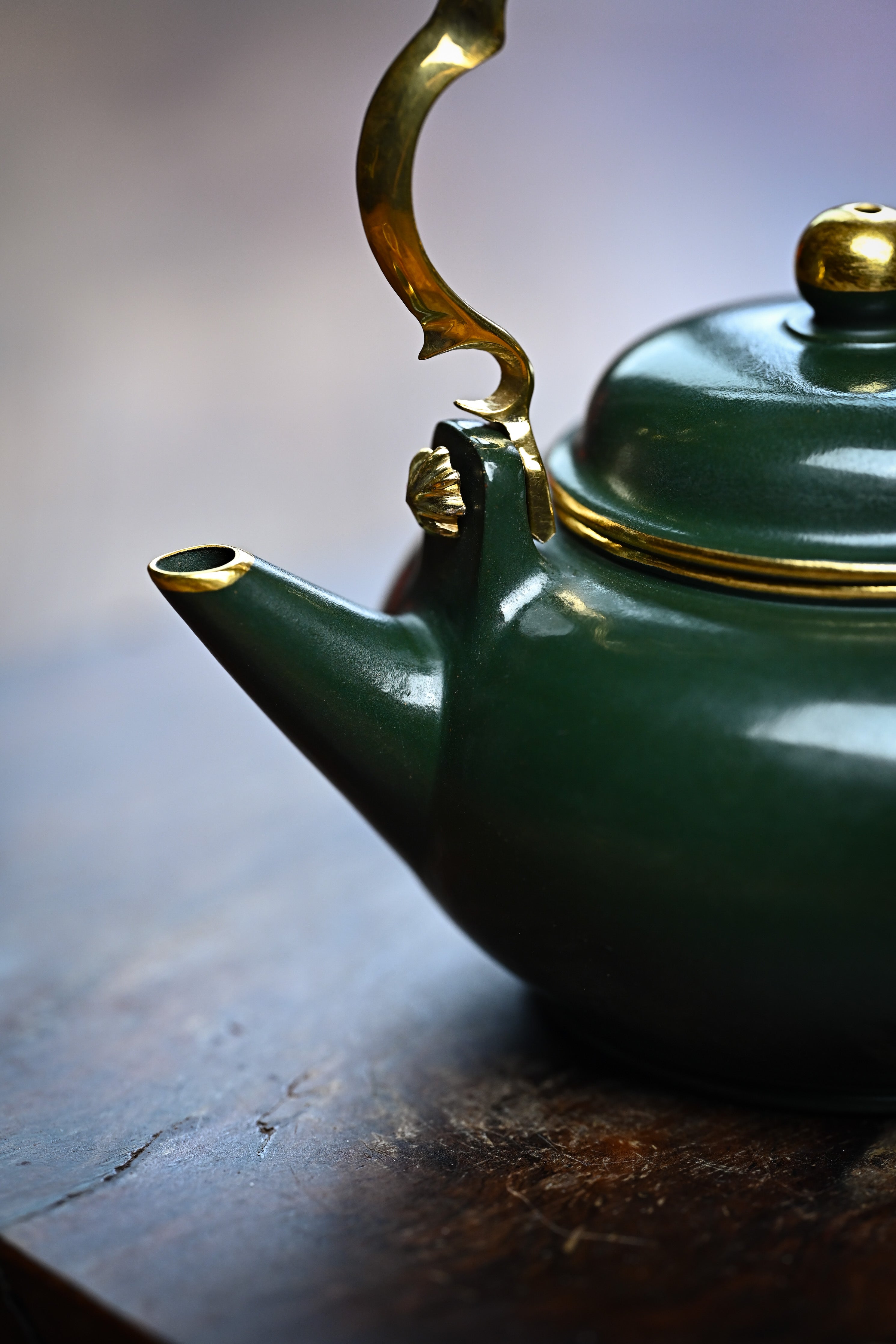 Handmade YANYOO Yixing teapot featuring Lvni clay and water-polished craftsmanship, lifestyle detail front.