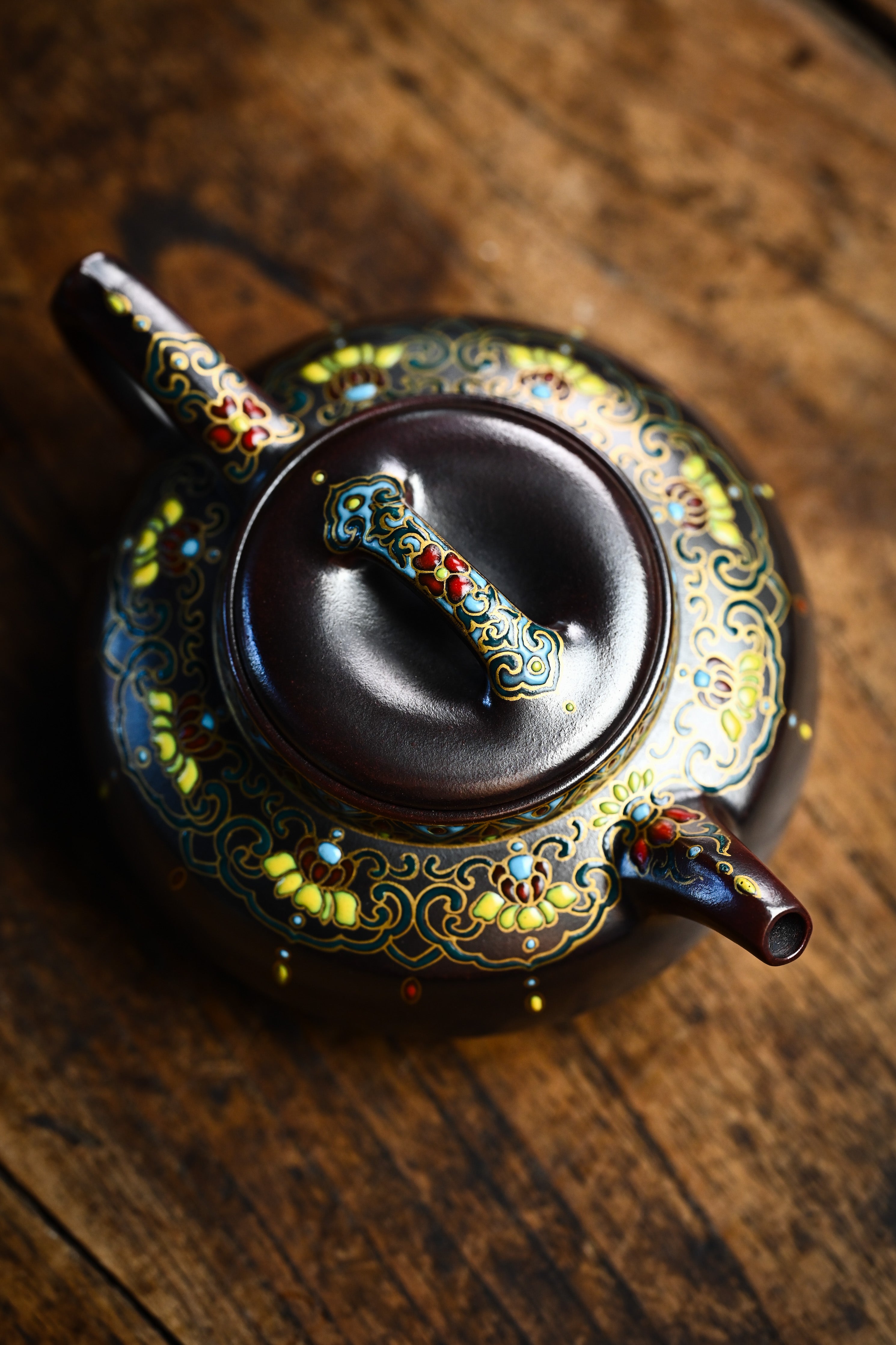 Handmade YANYOO Yixing teapot featuring Falangcai Ru Yi pattern, lifestyle top side.